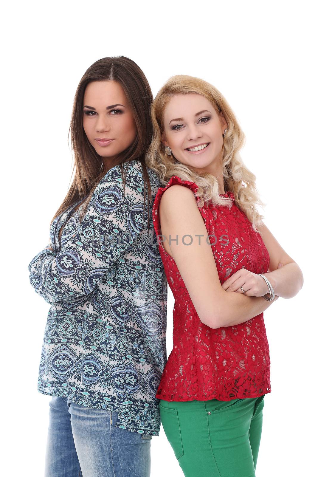 A brunette and a blonde girls are posing over a white background