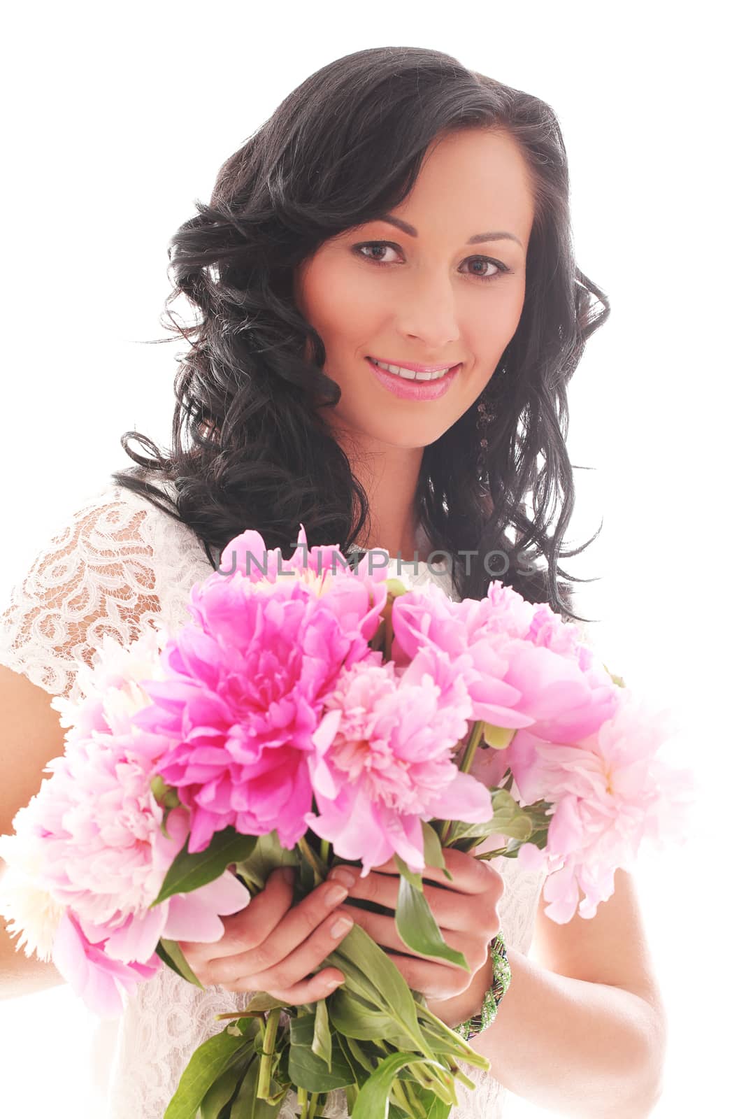Portrait of beautiful young woman with peonies bouquet on a white background