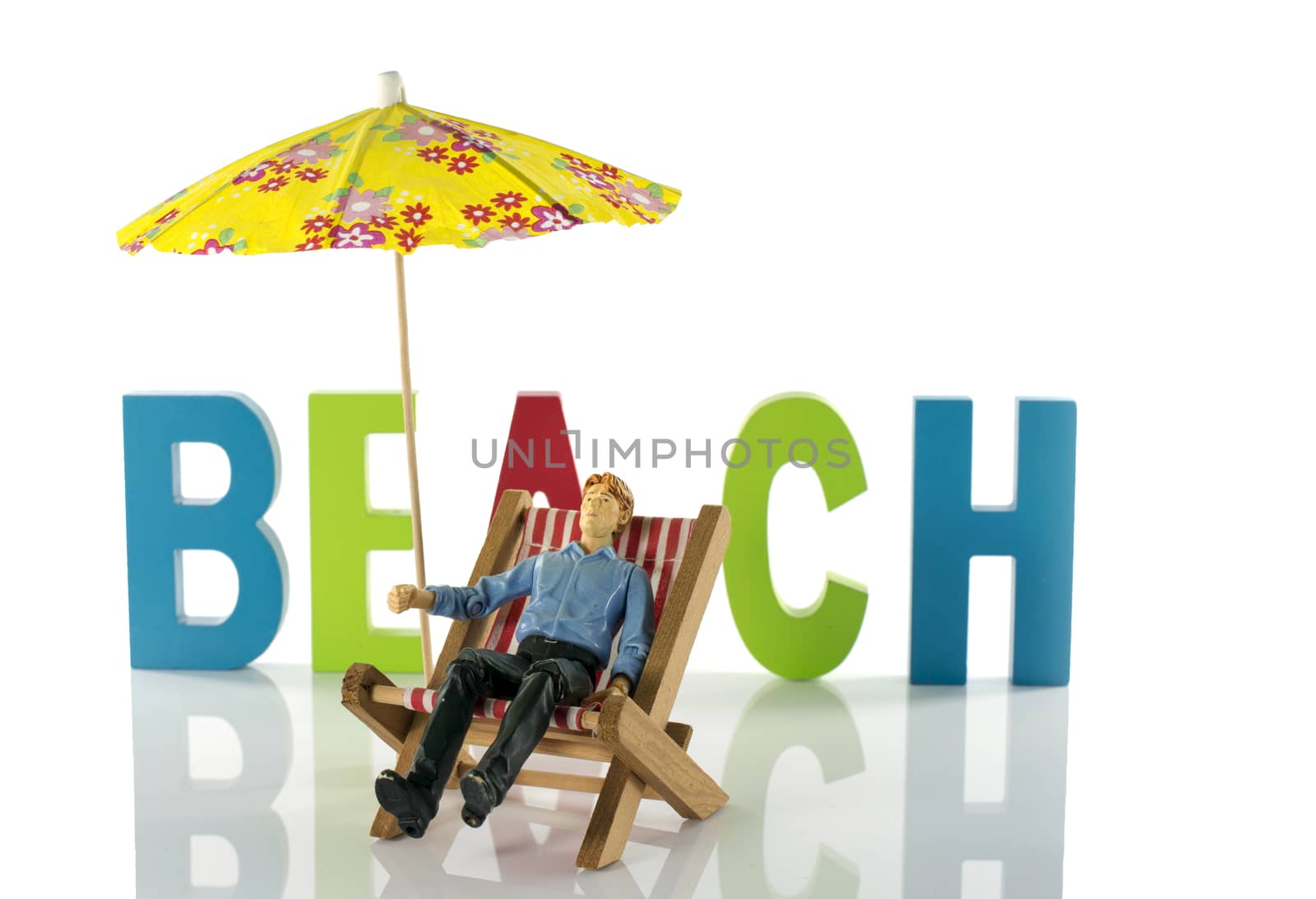 man in chair on the beach by compuinfoto