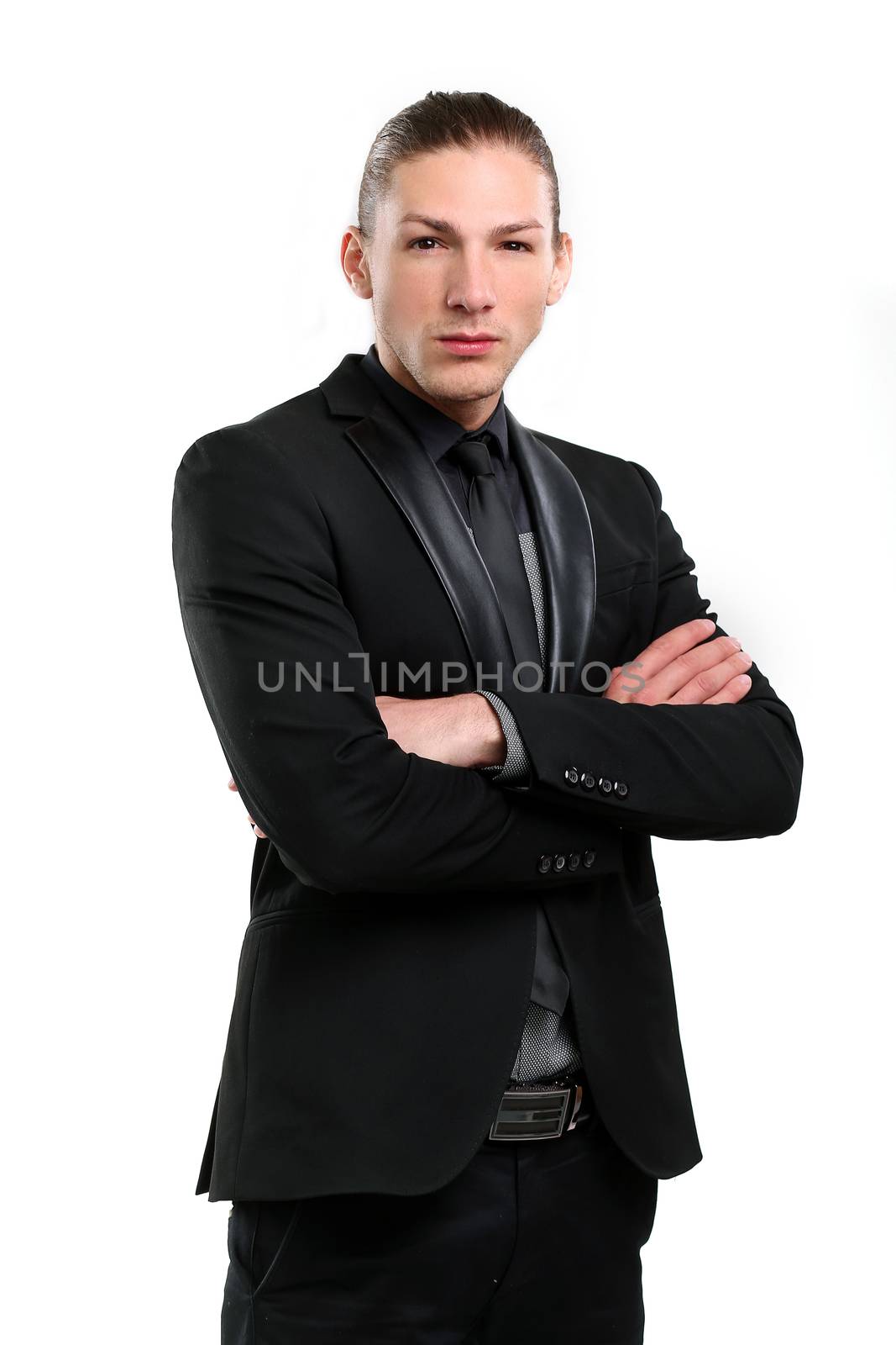Portrait of a handsome man in a black suit who is posing over a white background