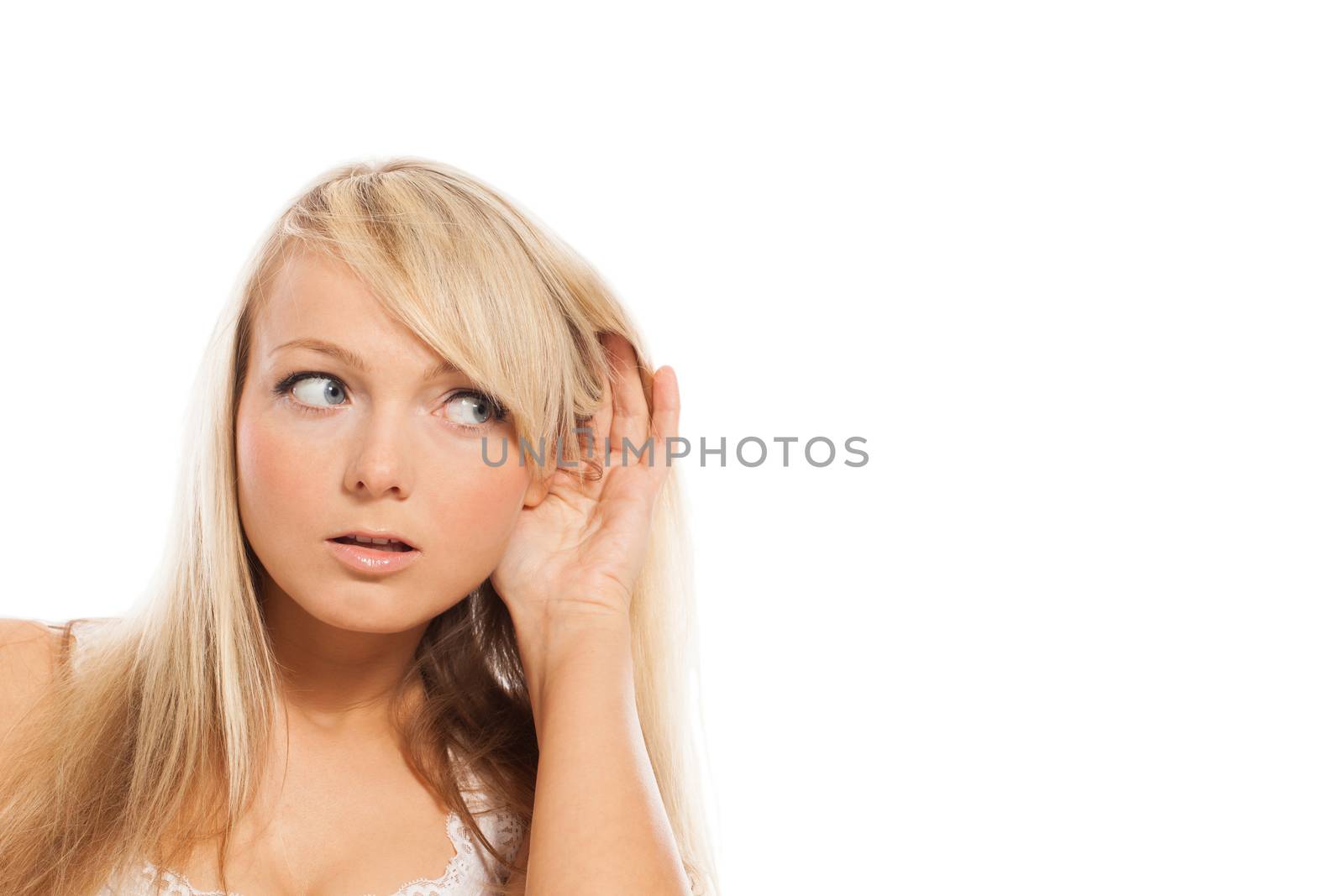 Young attractive woman holds hand at ear isolated over white background