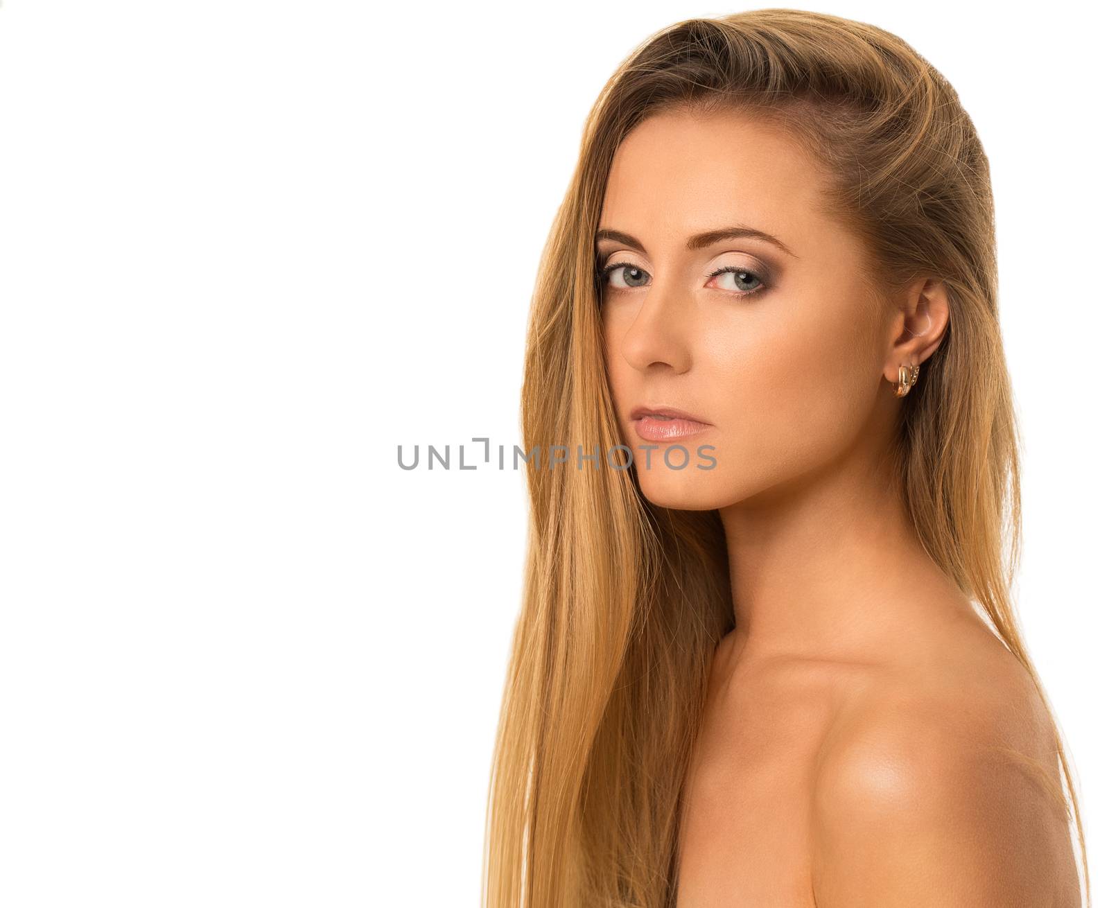 Portrait of a beautiful girl with naked shoulders who is posing over a white background