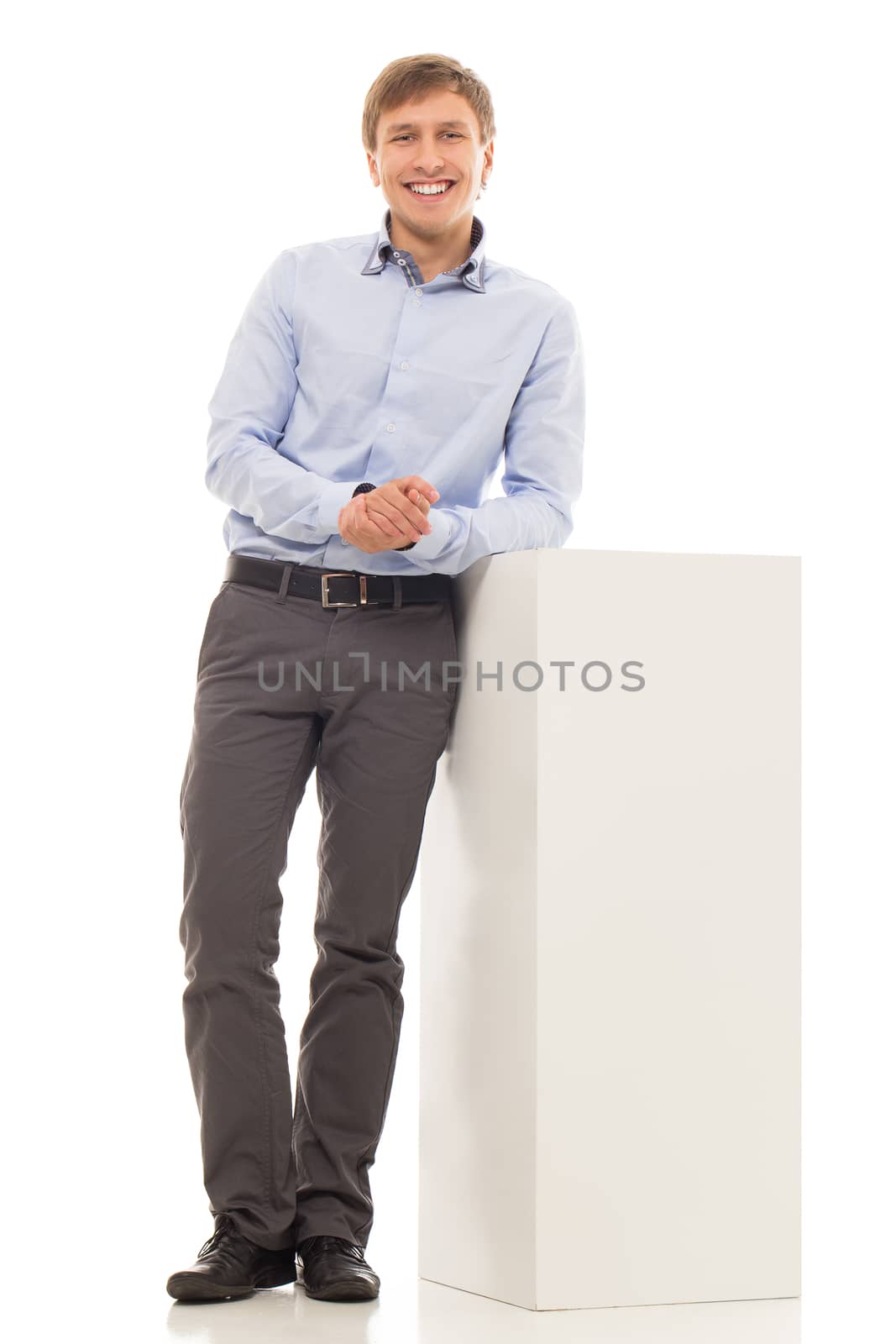 Handsome man in a blue shirt is standing near a part of diagram