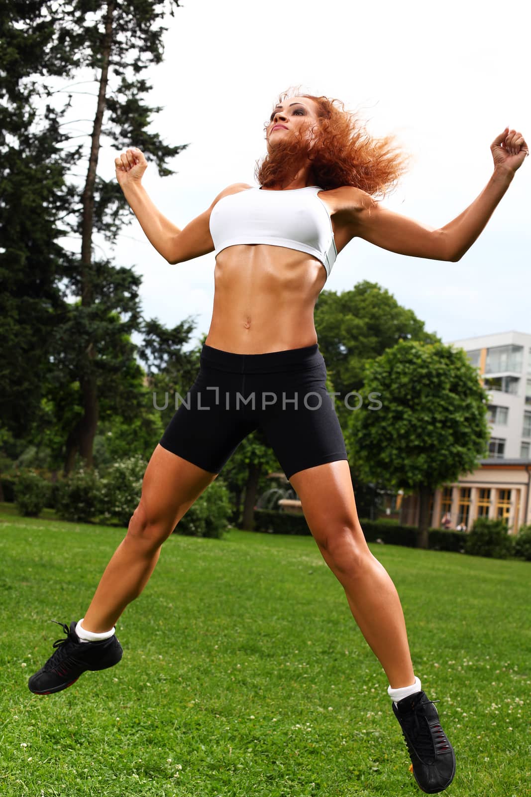 Beautiful middleaged caucasian woman working out in a park