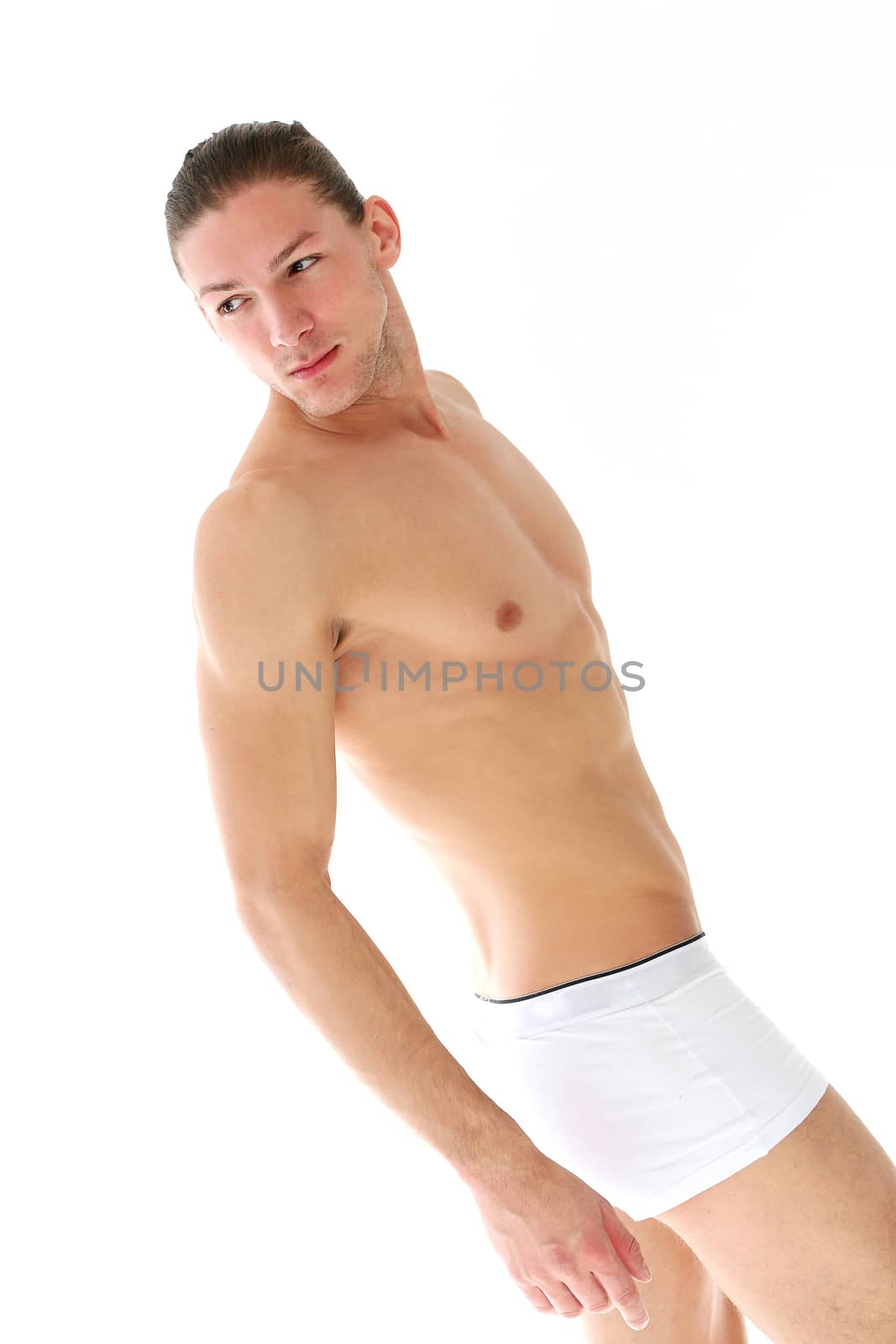 Portrait of a handsome shirtless man who is working out and posing over a white background