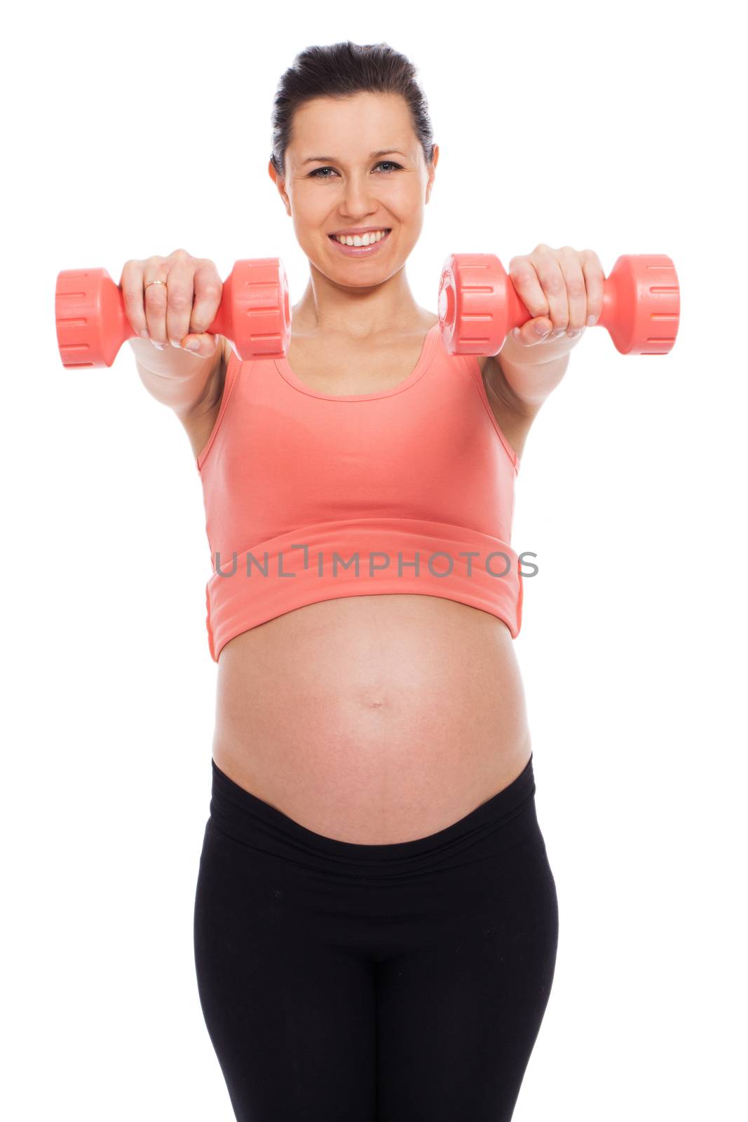 Beautiful pregnant woman working out with dumbbells isolated over white background