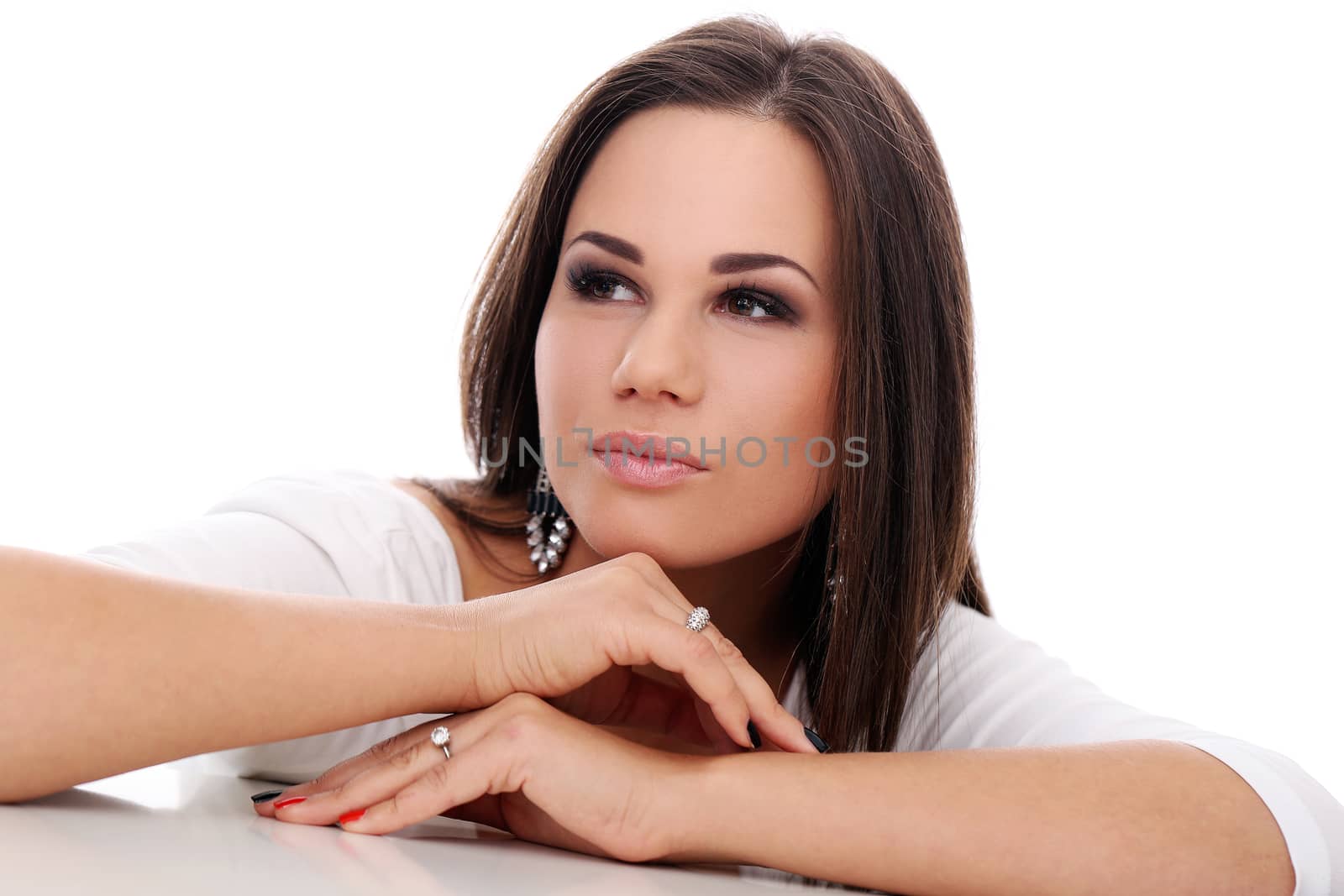 Portrait of a beautiful brown-haired girl who is posing over a white background