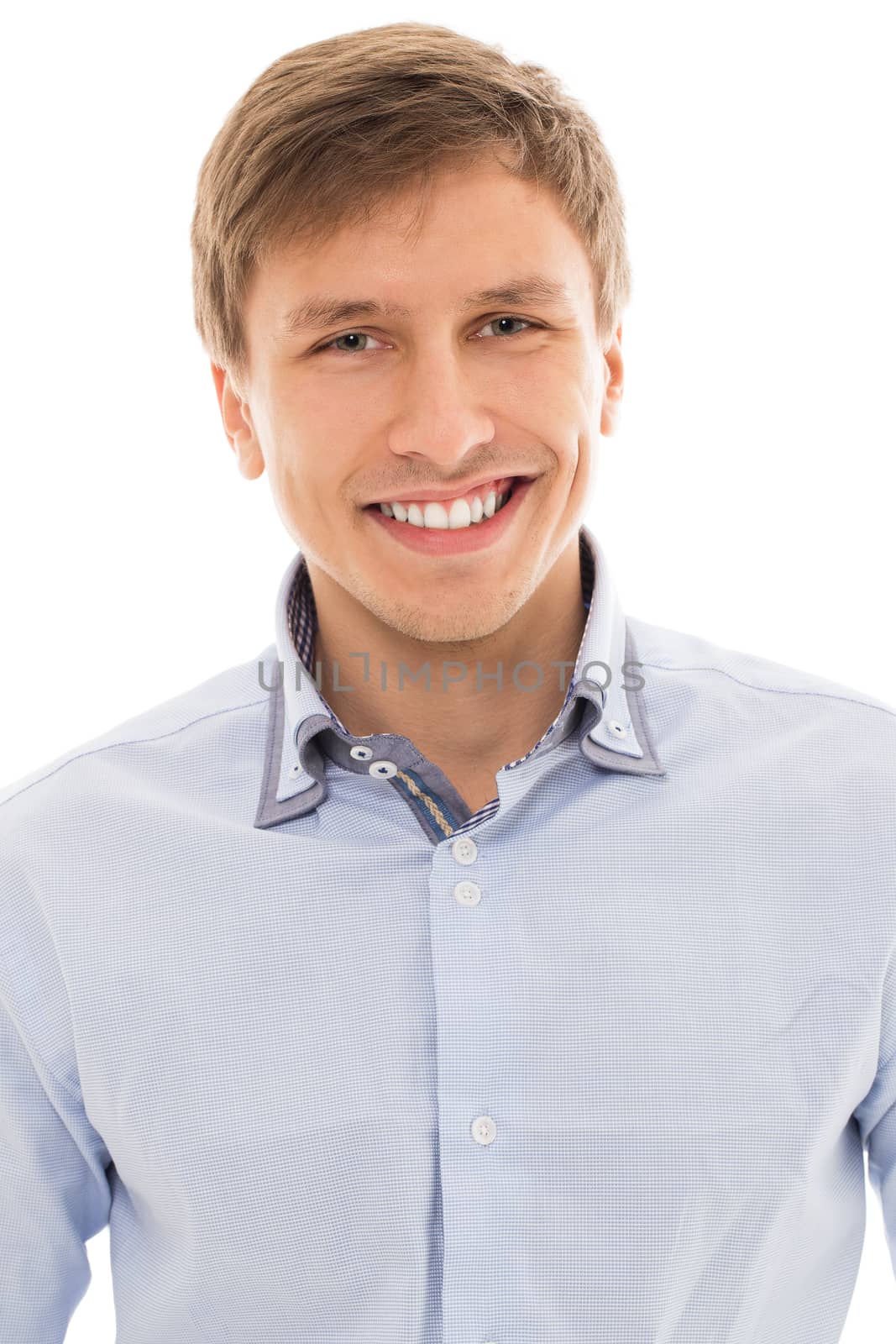Handsome man in a blue shirt smiling over a white background