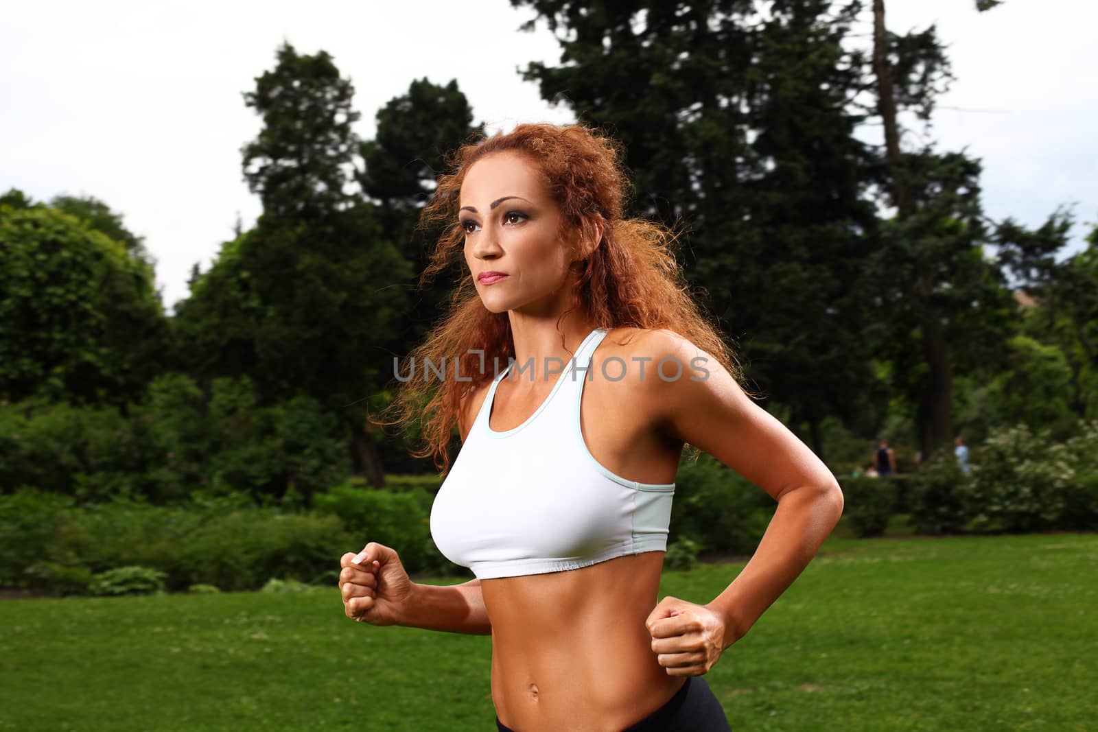 Beautiful middleaged caucasian woman working out in a park