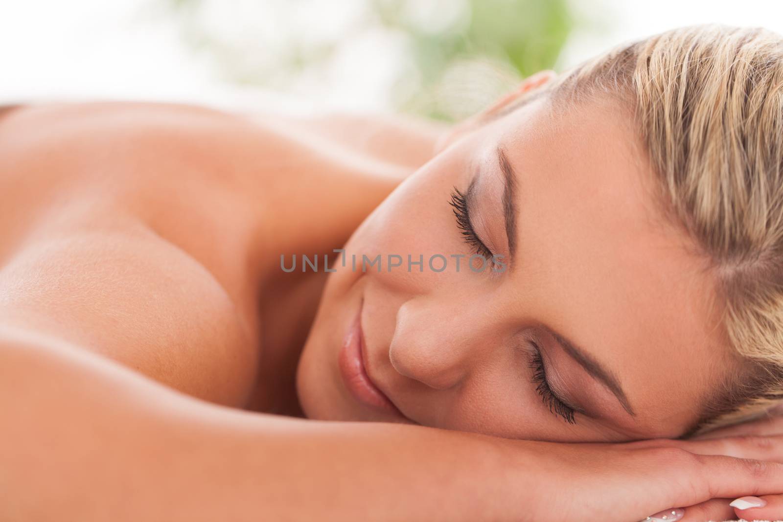 Beautiful woman lying in a spa by rufatjumali