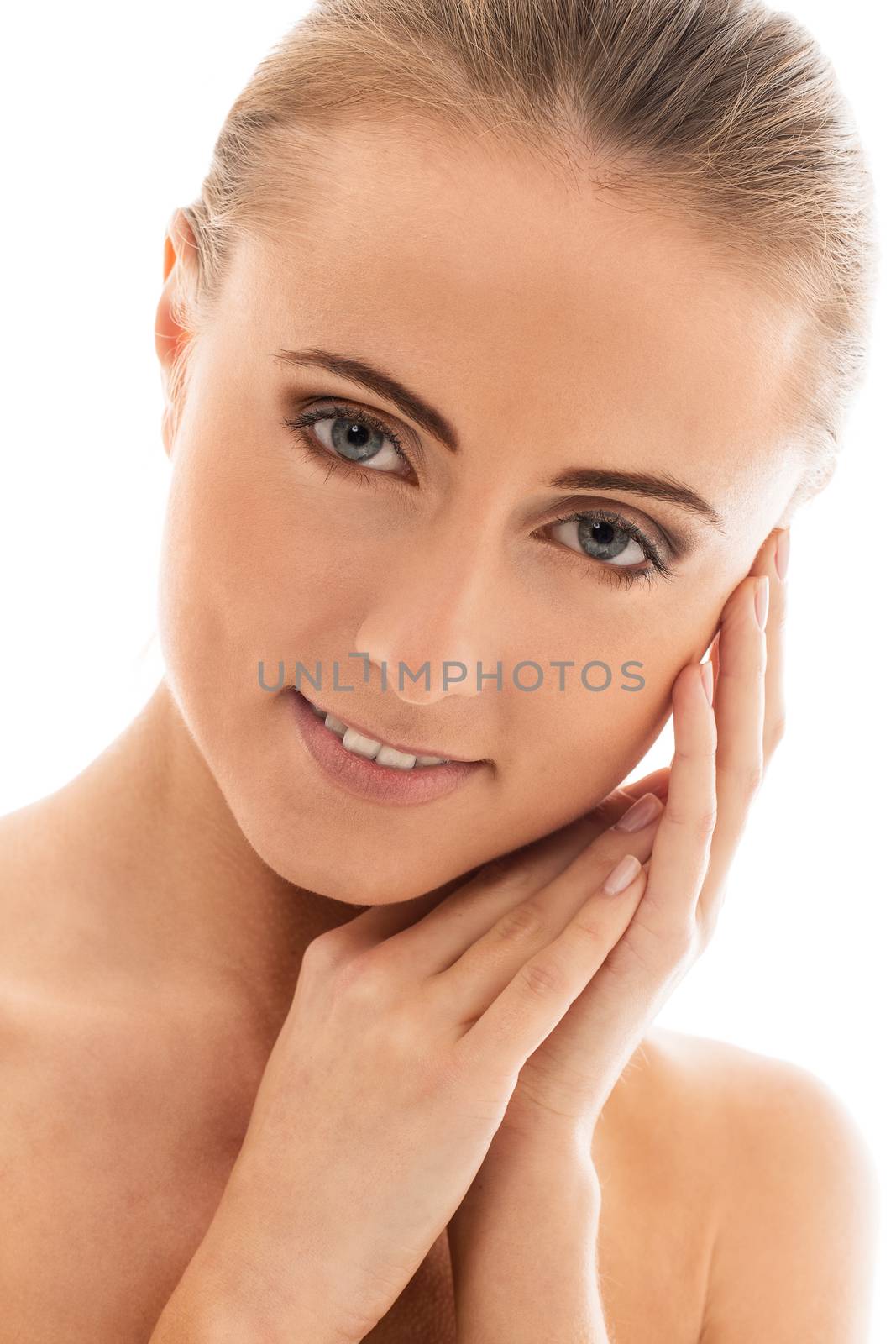 Portrait of a beautiful girl with naked shoulders who is posing over a white background