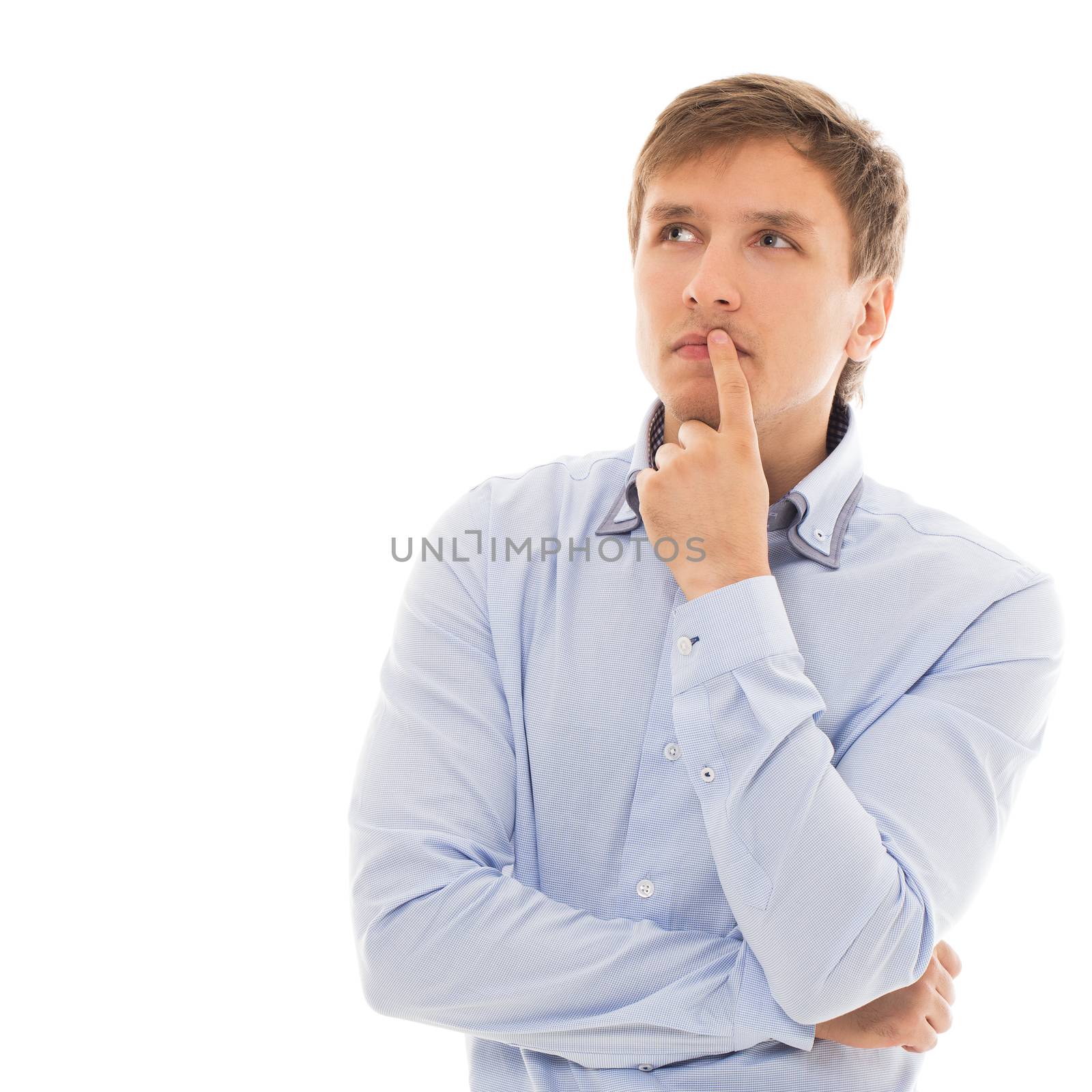 Handsome man in a blue shirt is thinking over a white background