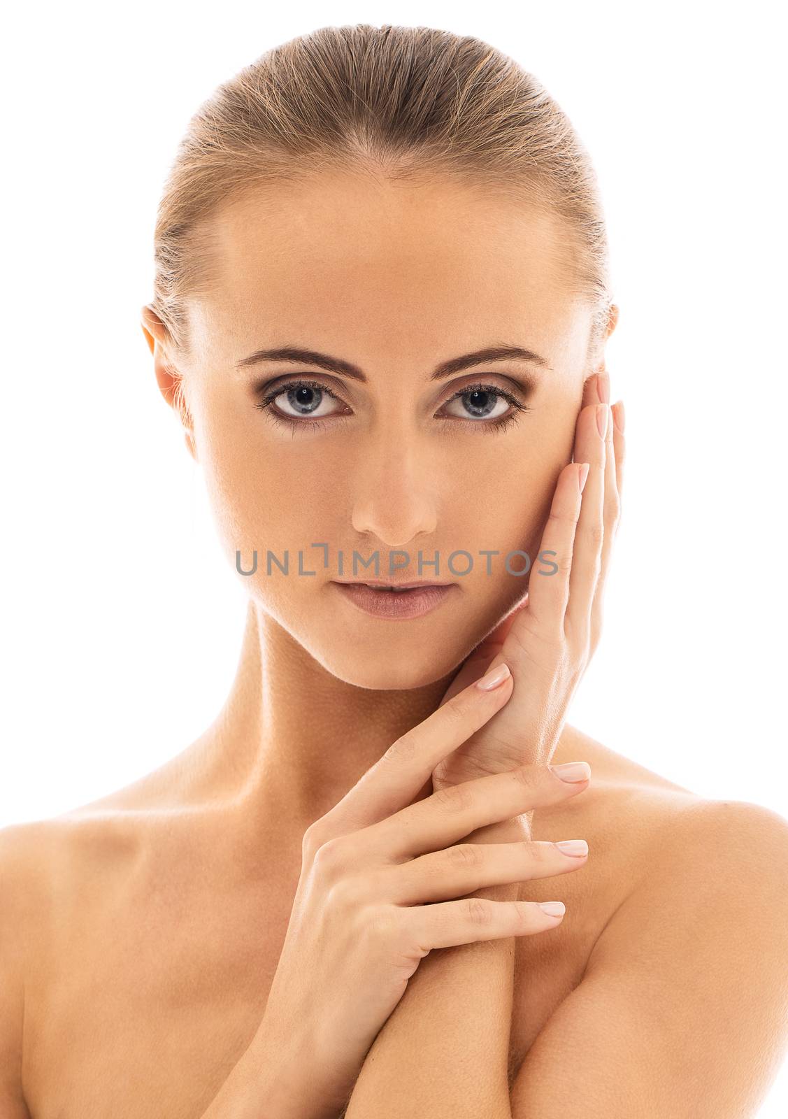 Portrait of a beautiful girl with naked shoulders who is posing over a white background