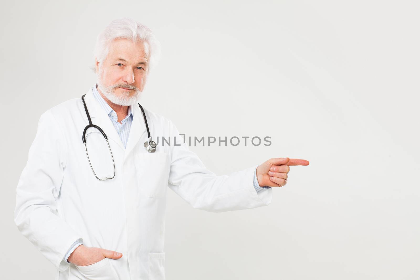 Handsome elderly doctor in uniform isolated over light background