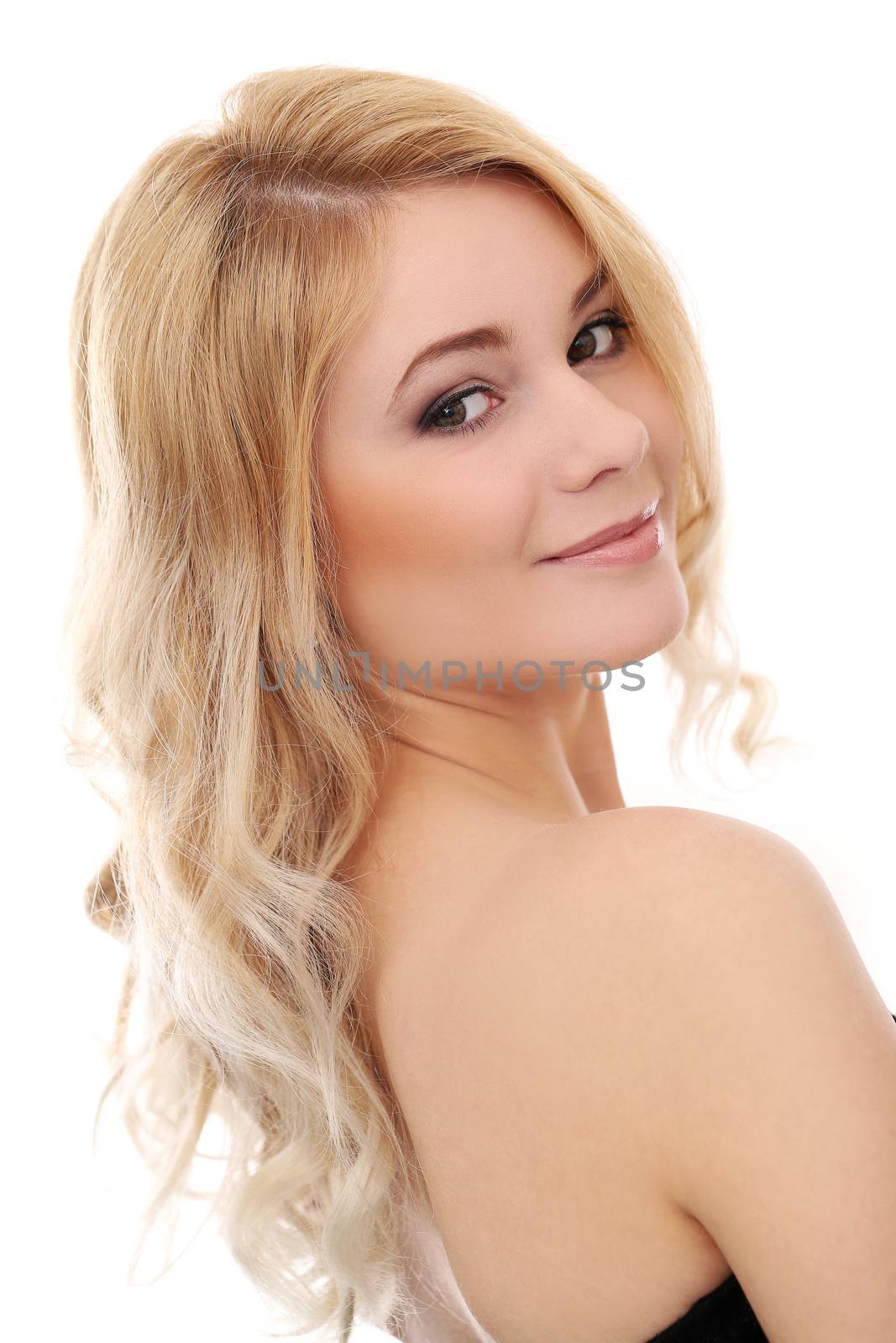 Portrait of a beautiful blonde girl with curly hair who is posing over a white background
