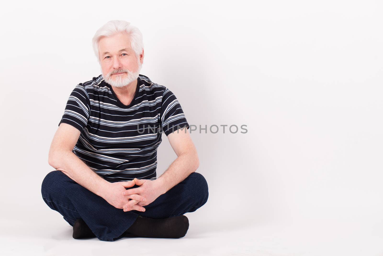 Handsome elderly man sitting by rufatjumali