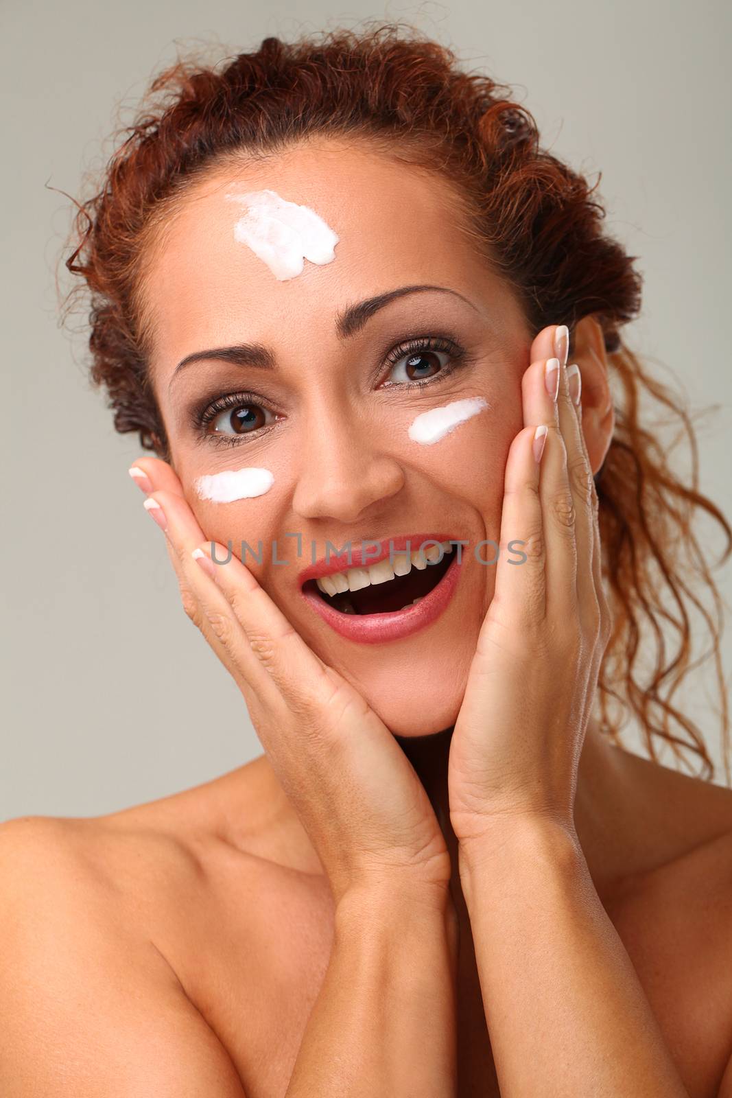 Beautiful middleaged caucasian woman with cream on her face