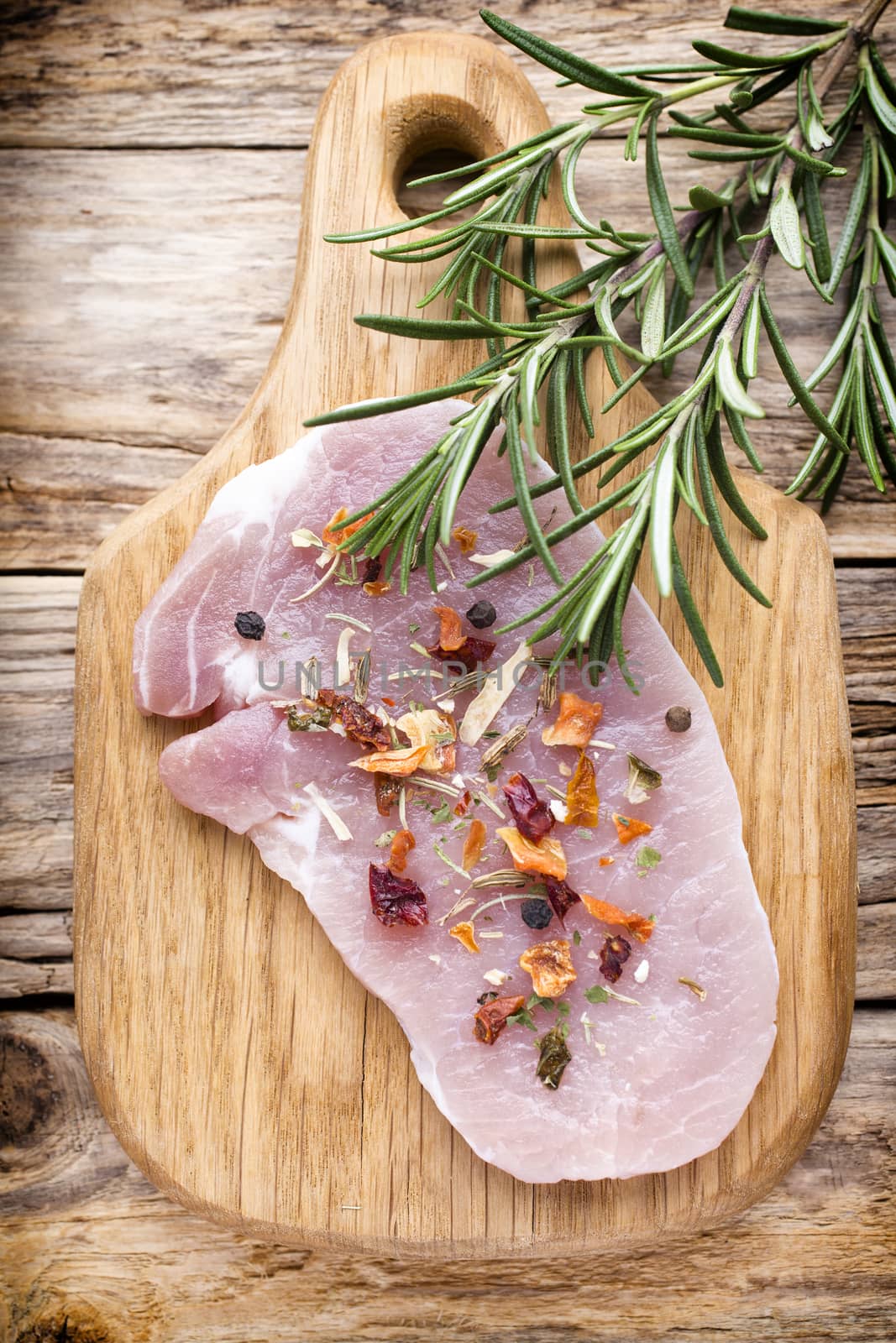 Pork chop, meat slices  on a wood background.