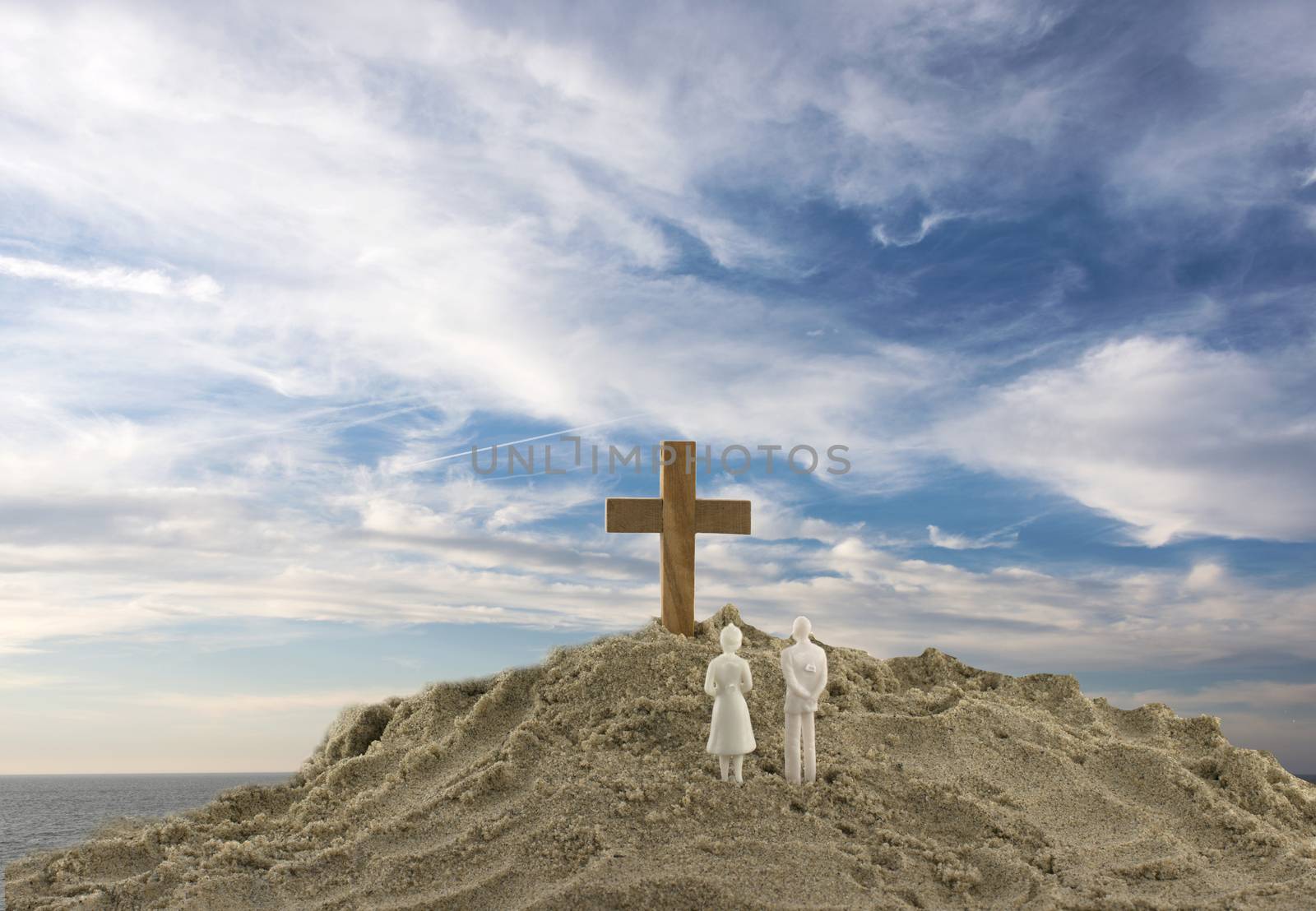 people looking at the holy cross with clouds and sea as backgrou by compuinfoto