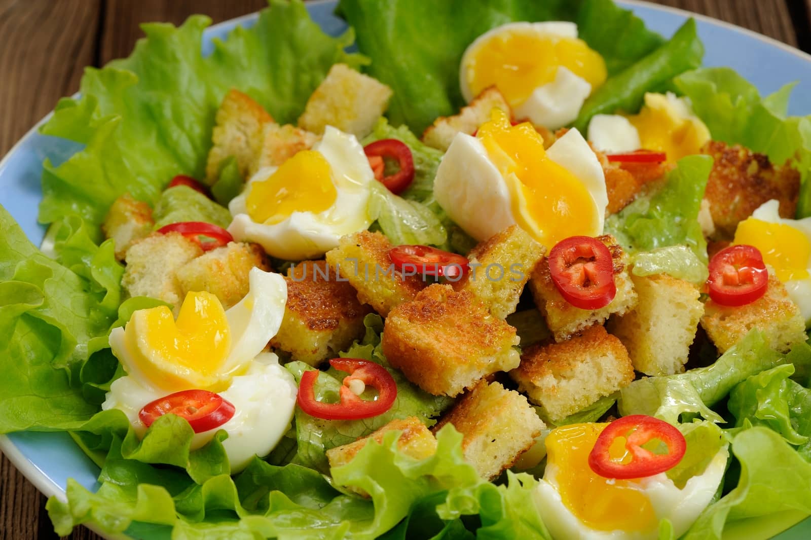 Salad Caesar with eggs, chili pepper closeup macro by Borodin
