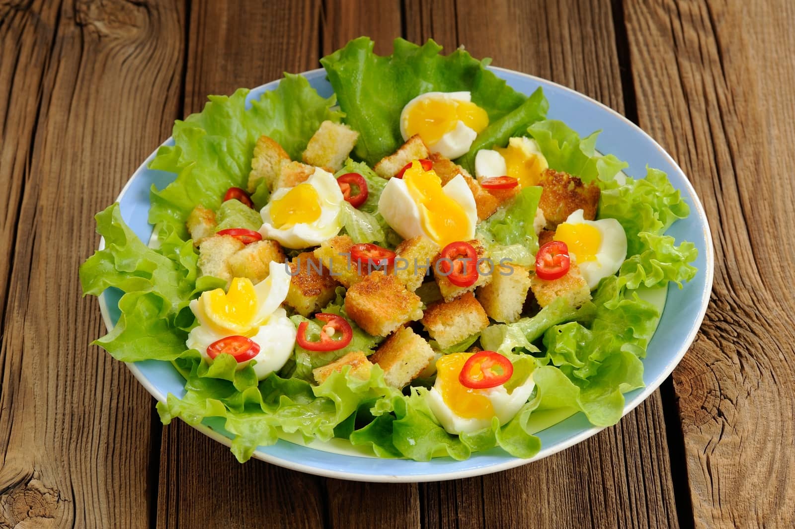 Salad Caesar with eggs, chili pepper closeup macro horizontal