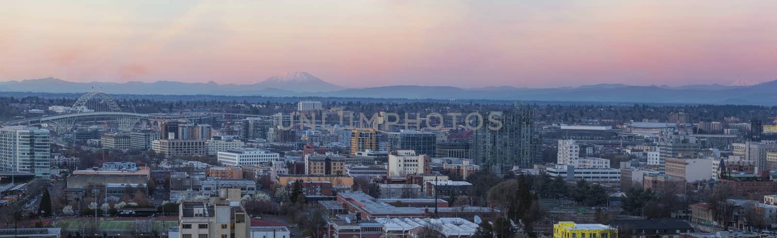 View of Portland Oregon Pearl District Cityscape with Mt St Helens and Mt Adams Fremont Bridge during Sunset Panorama