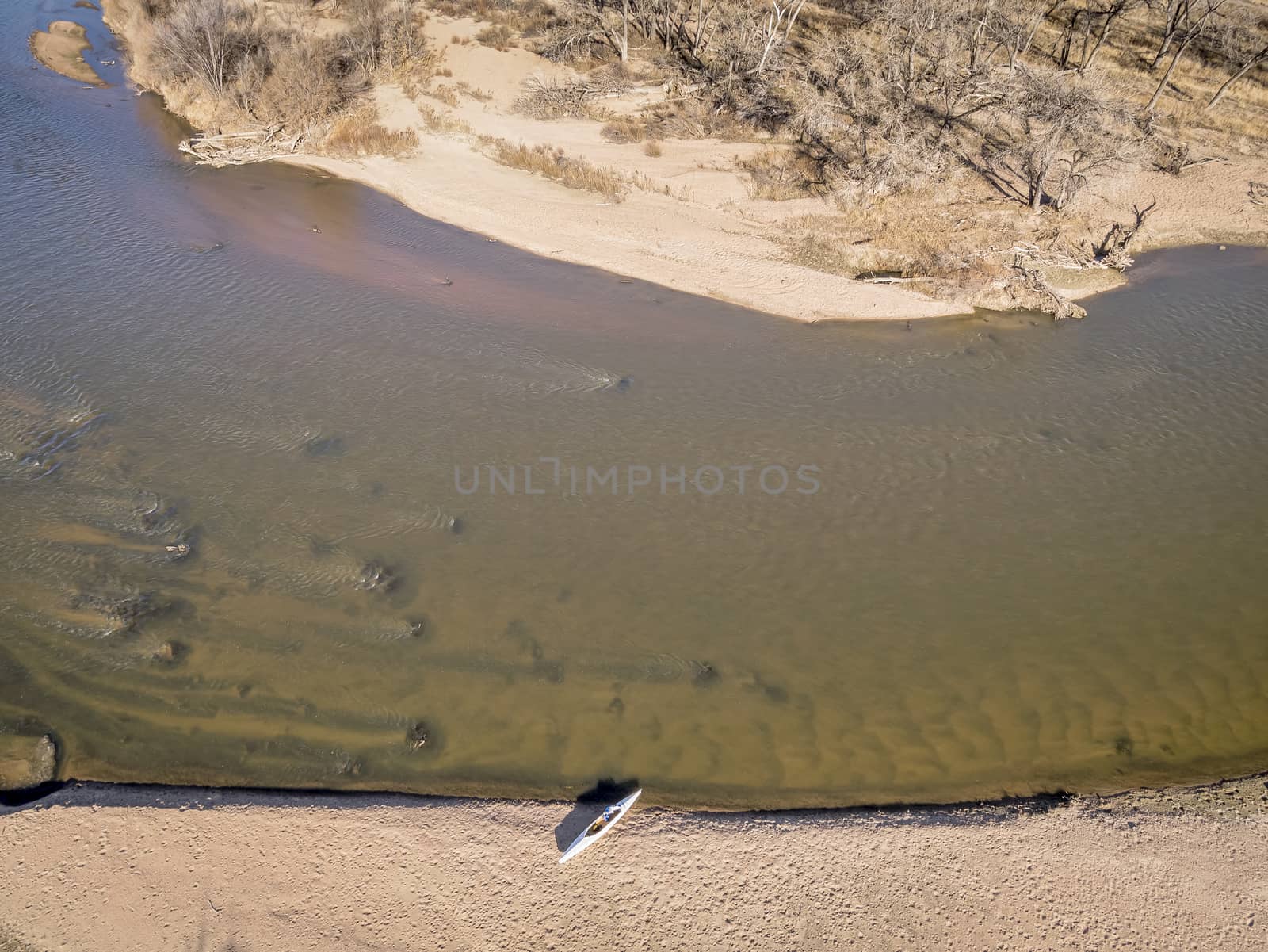 aerial view of South Platte River in eastern Colorado below Platteville with a canoe on sandbar, a typical winter scenery with a low flow