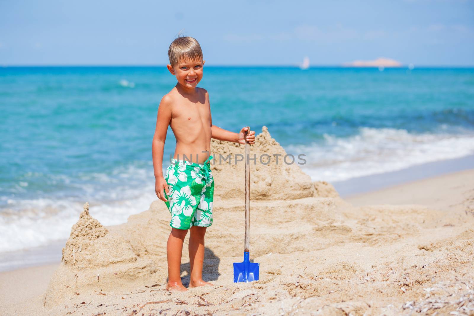 Young boy playing in the sand on the beach