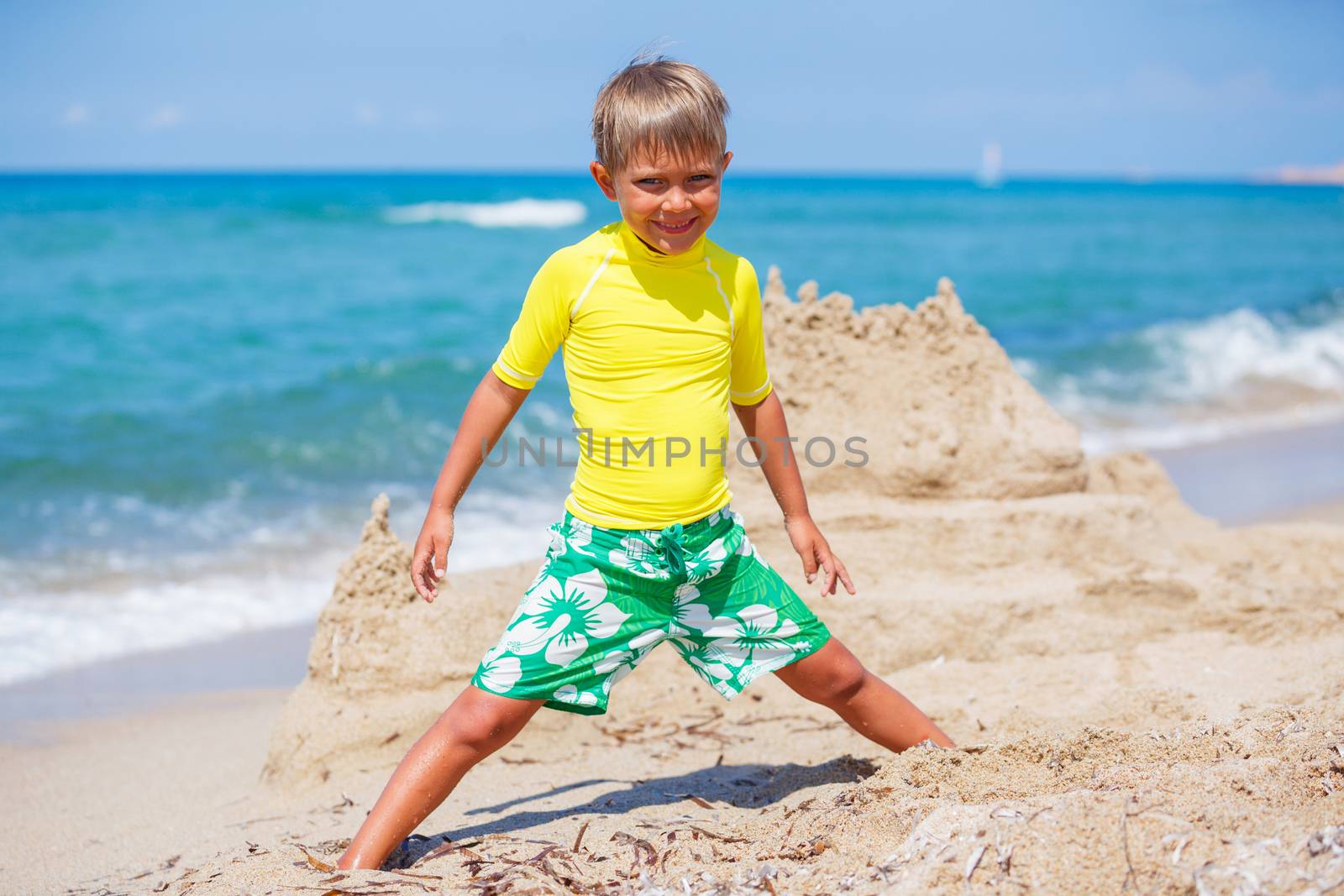 Young boy playing in the sand on the beach