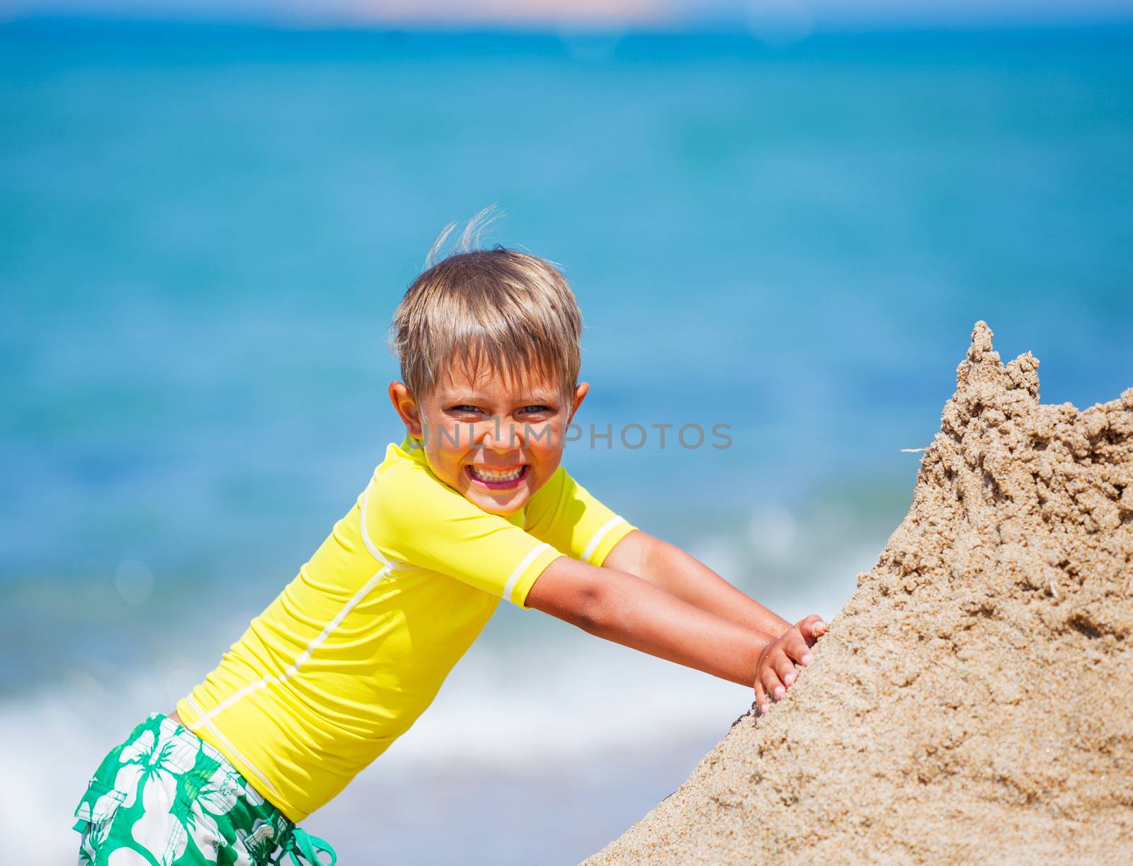 Young boy playing in the sand on the beach