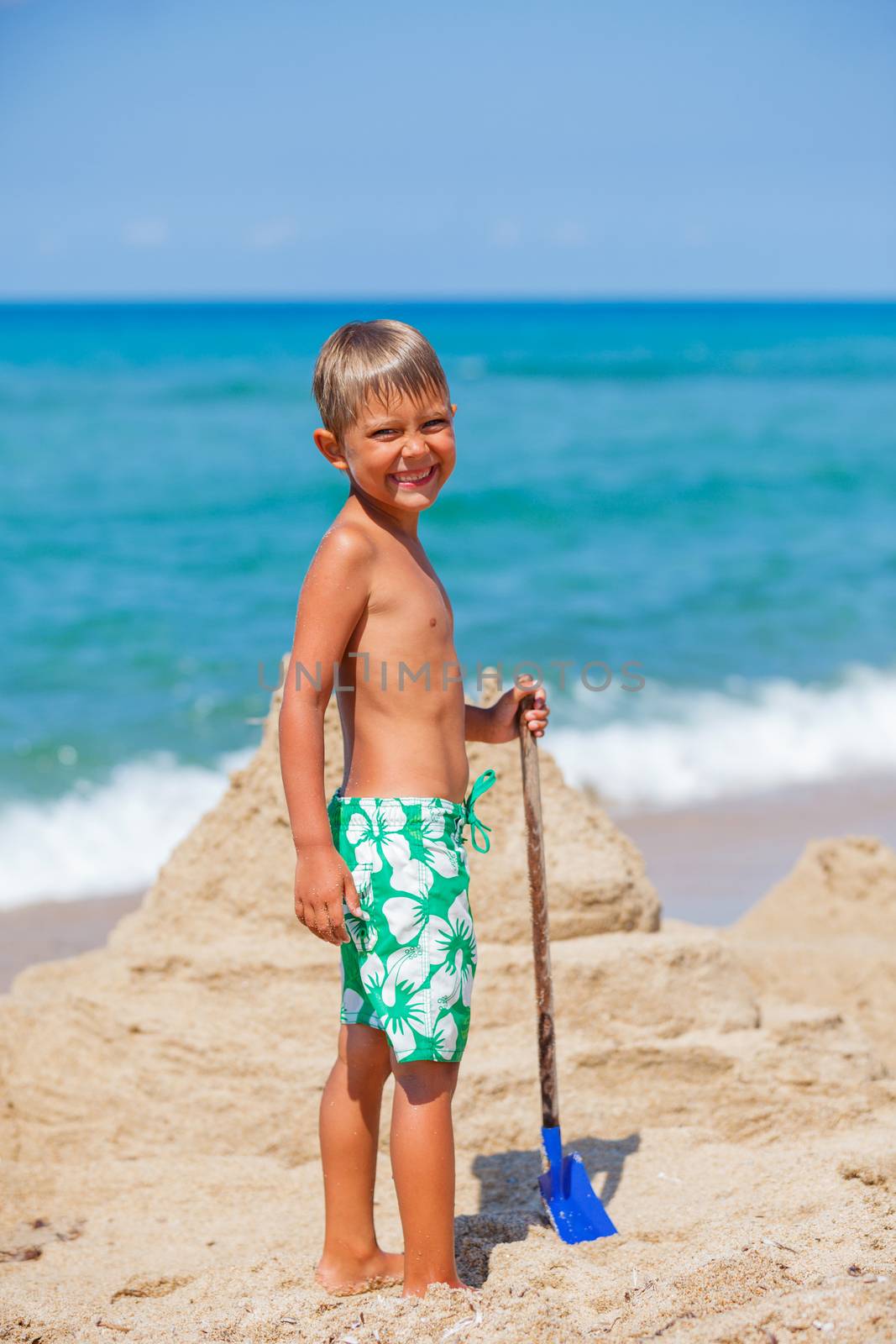 Young boy playing in the sand on the beach