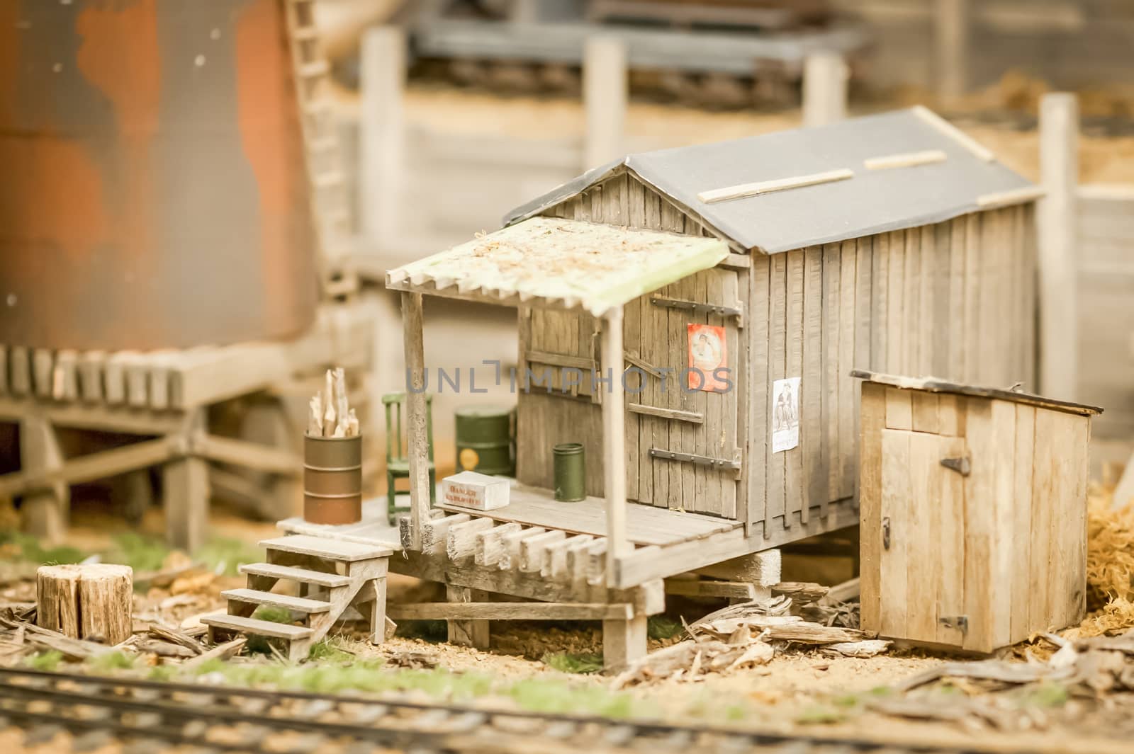 miniature model of a rundown wooden shack beside a railroad - shallow d.o.f.