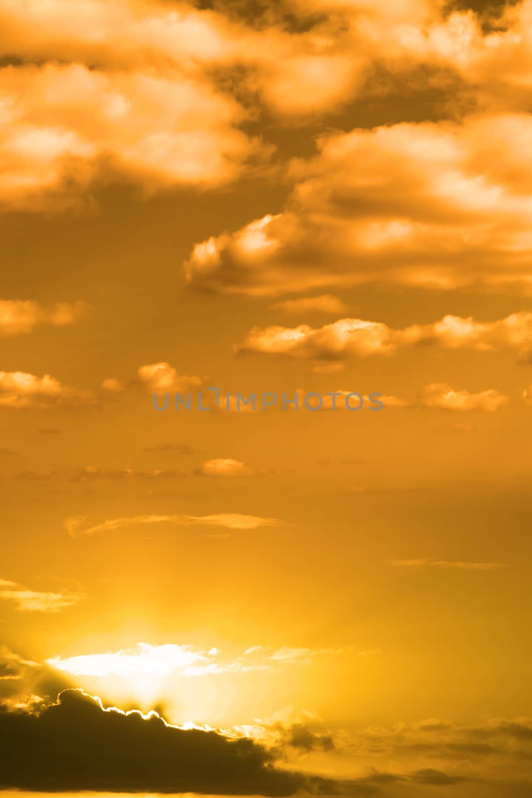beautiful cloudy orange sunset sky in the wild Atlantic way, Ireland with sunbeams