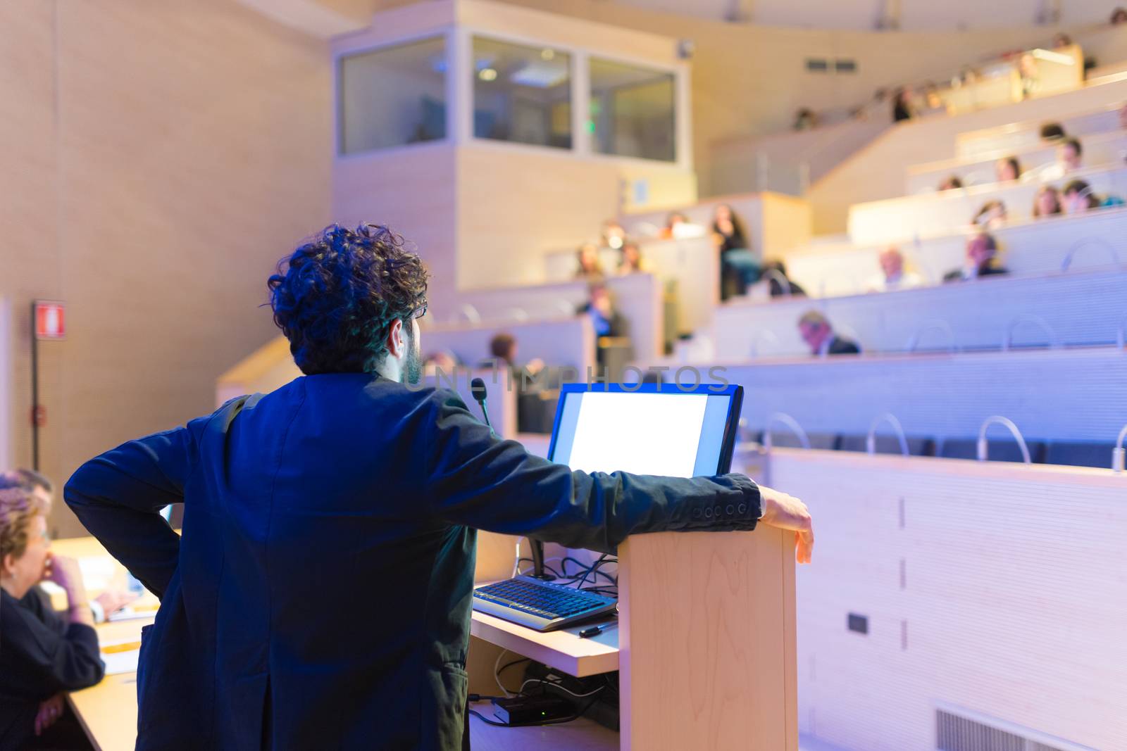 Speaker giving talk on podium at Business Conference. by kasto