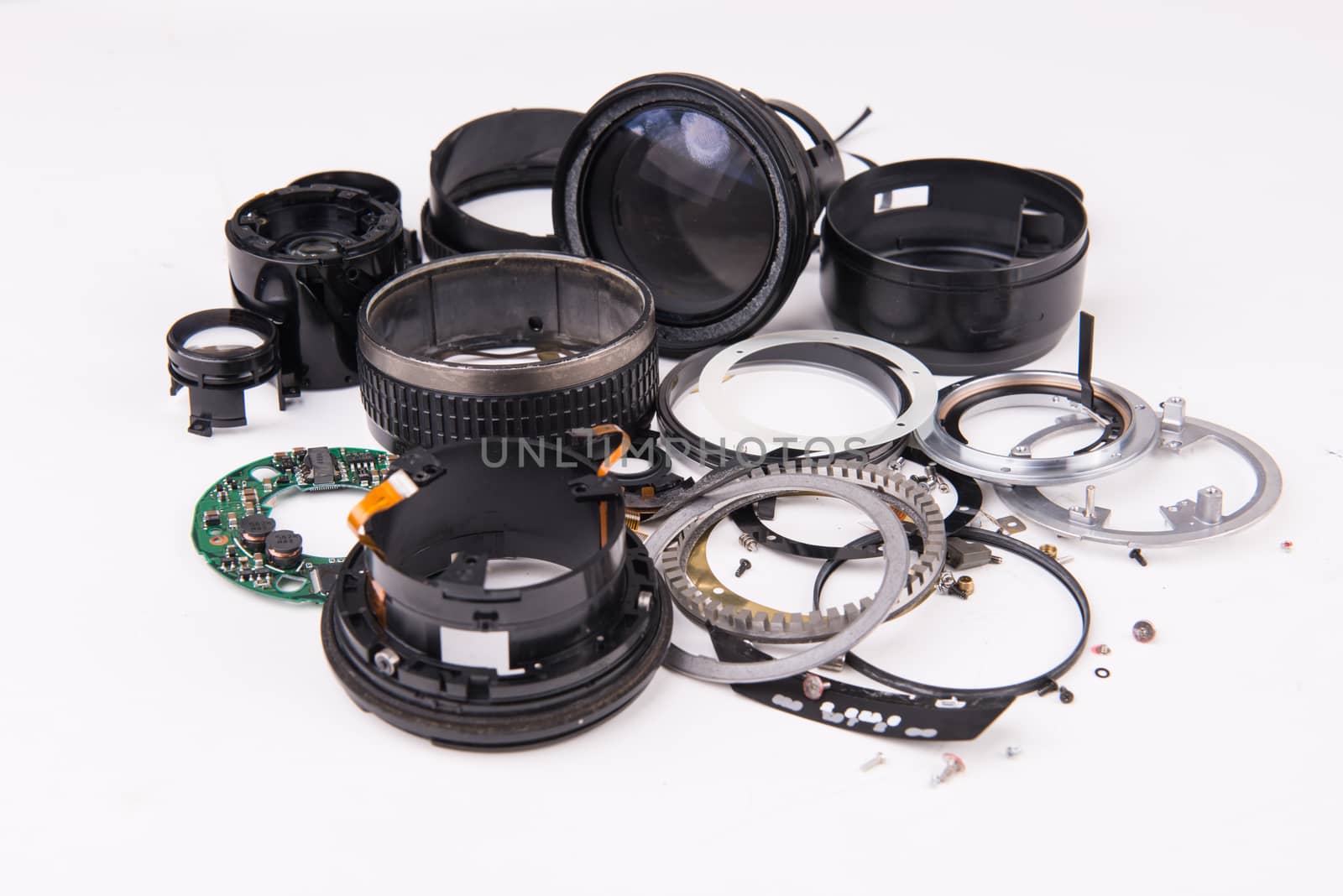 camera lens has been dropped and shattered on white background