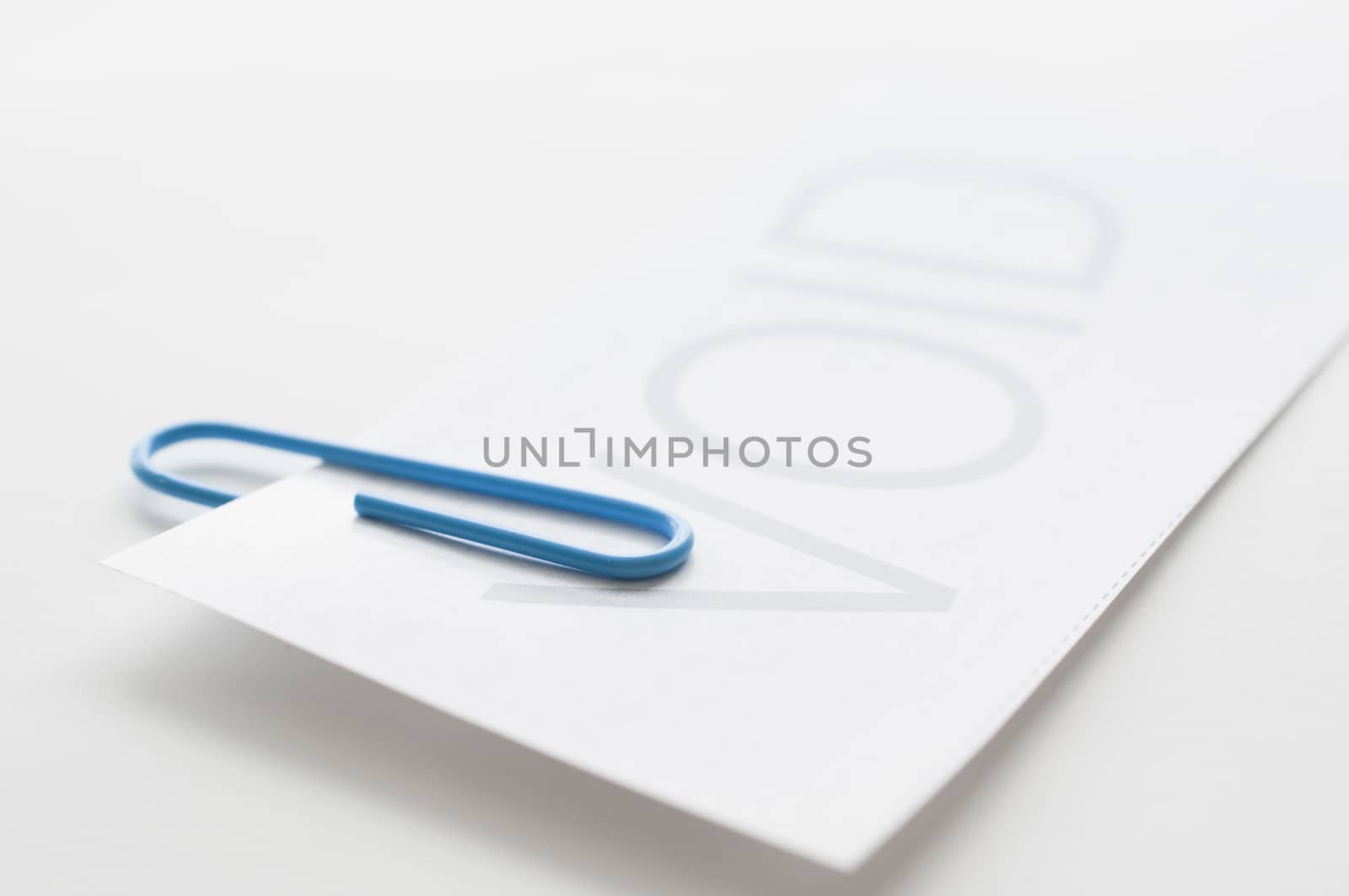 Void paper with blue paper clip on white background