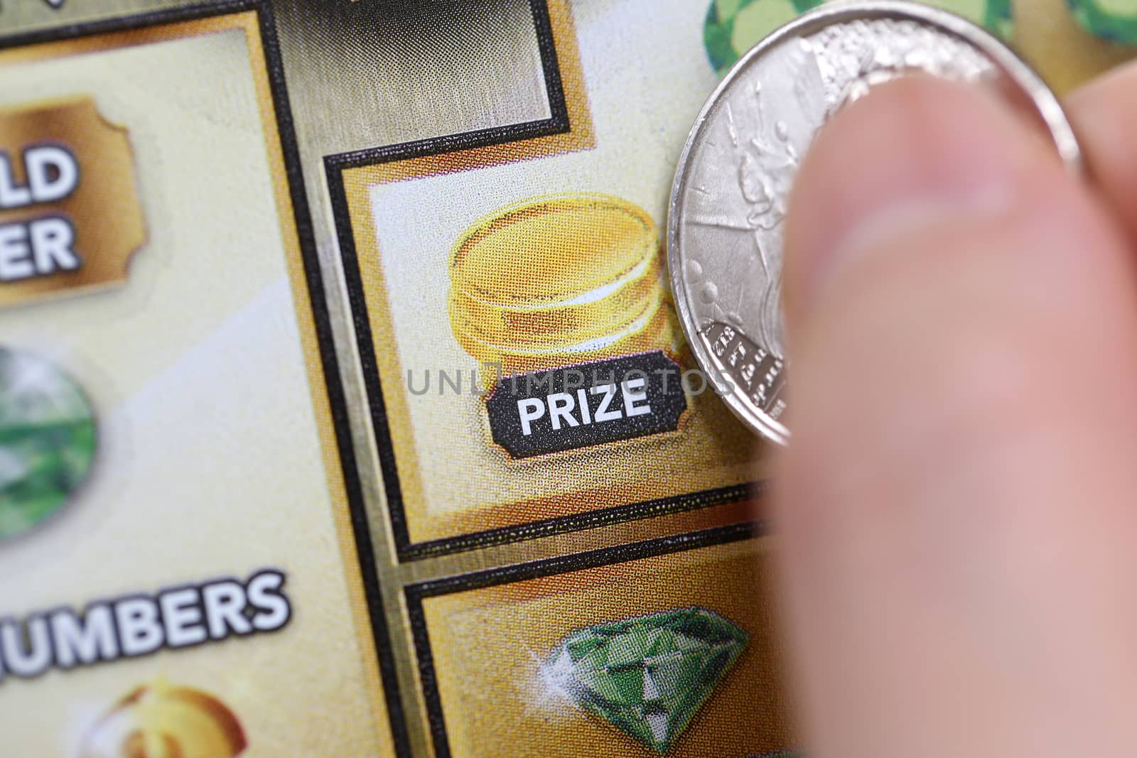 Coquitlam BC Canada - June 15, 2014 : Woman scratching lottery ticket called lucky 7. It's published by BC Lottery Corporation has provided government sanctioned lottery games in British Columbia since 1985. 