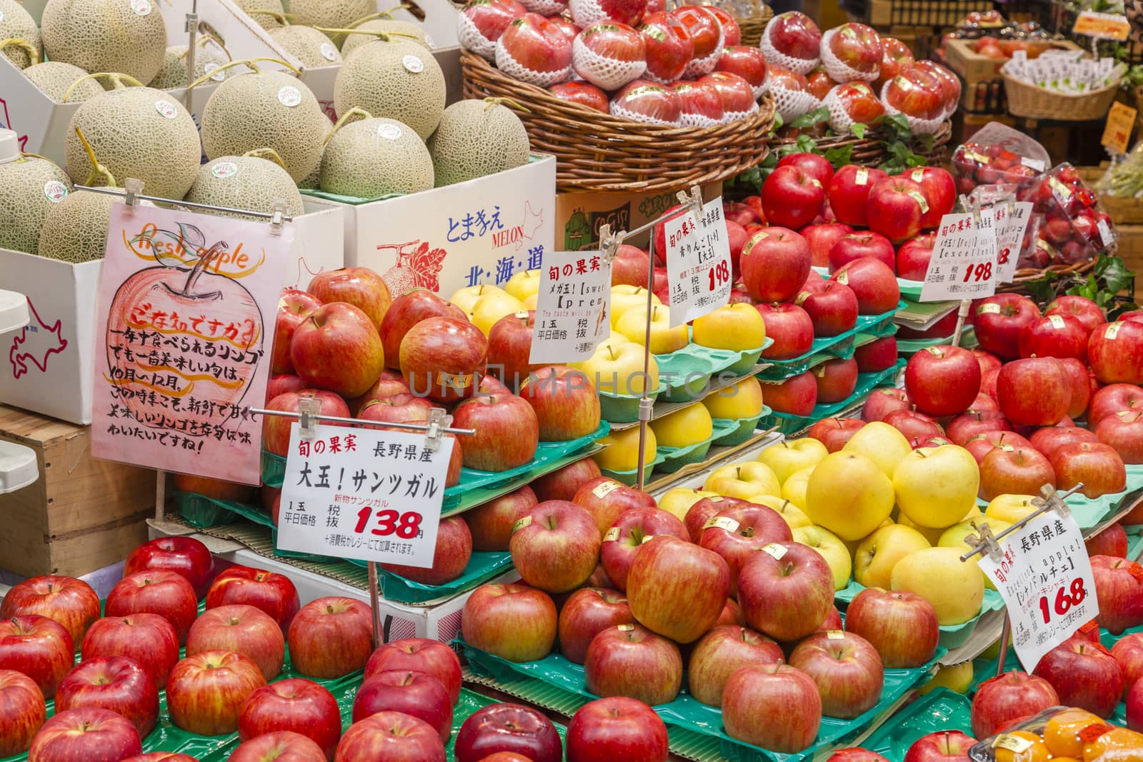 Osaka, Japan - October 26, 2014: Fresh fruits in a greengrocery in Kuromon Market in Osaka, Japan. The Kuromon Market has been called 'Osaka's Kitchen' since it opened as many cooks in Osaka come here to get the ingredients.