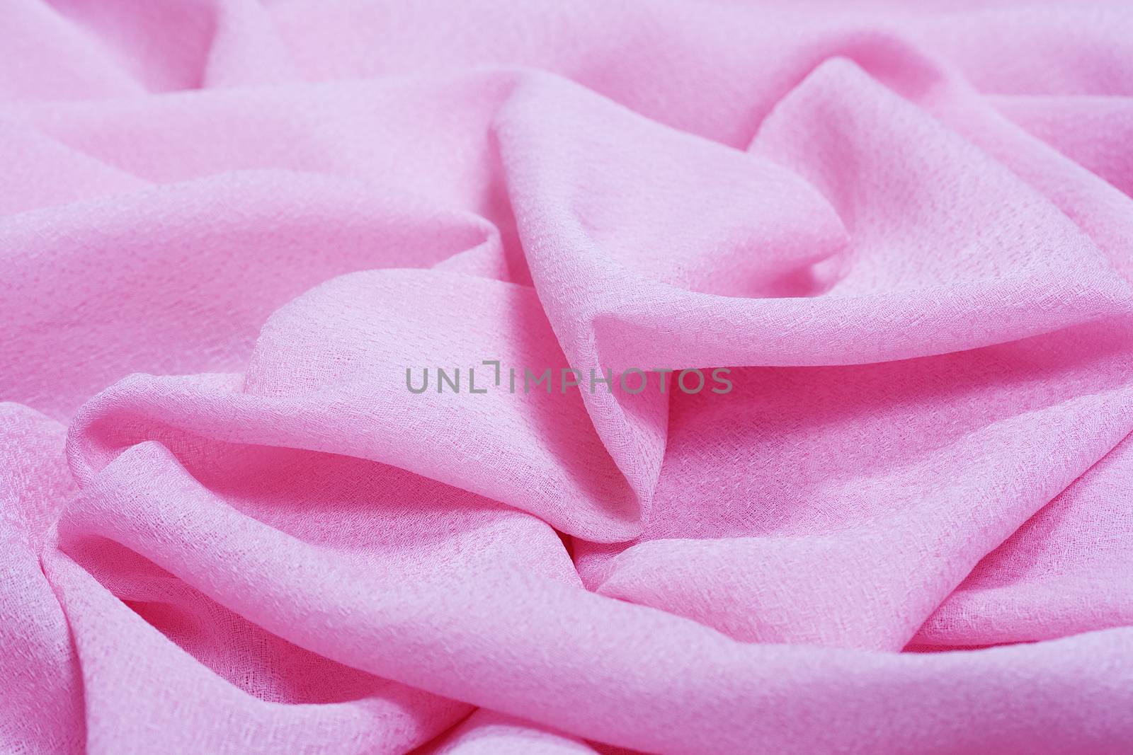Delicate pink cotton fabric with many folds