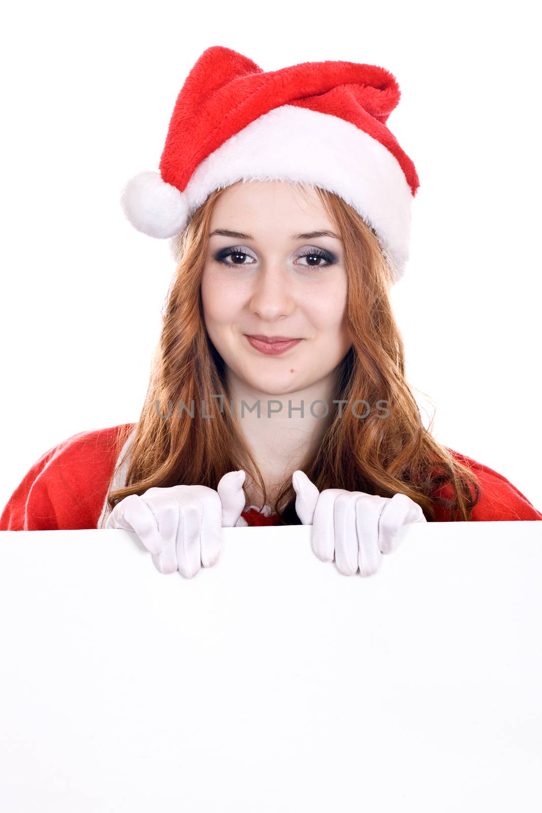 Young woman in Mrs Santa Claus hat holding a blank sign. Isolated on white.