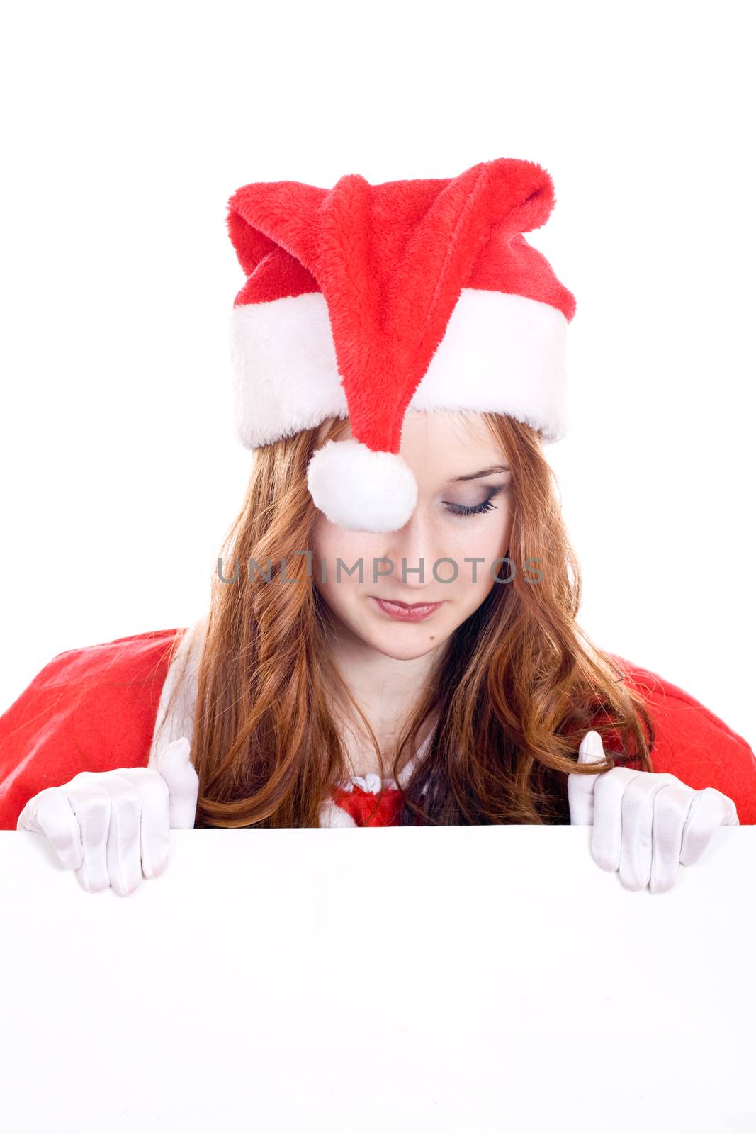 Young woman in Mrs Santa Claus hat holding a blank sign. Isolated on white. Extra white space with your message can be added to the bottom of the picture.