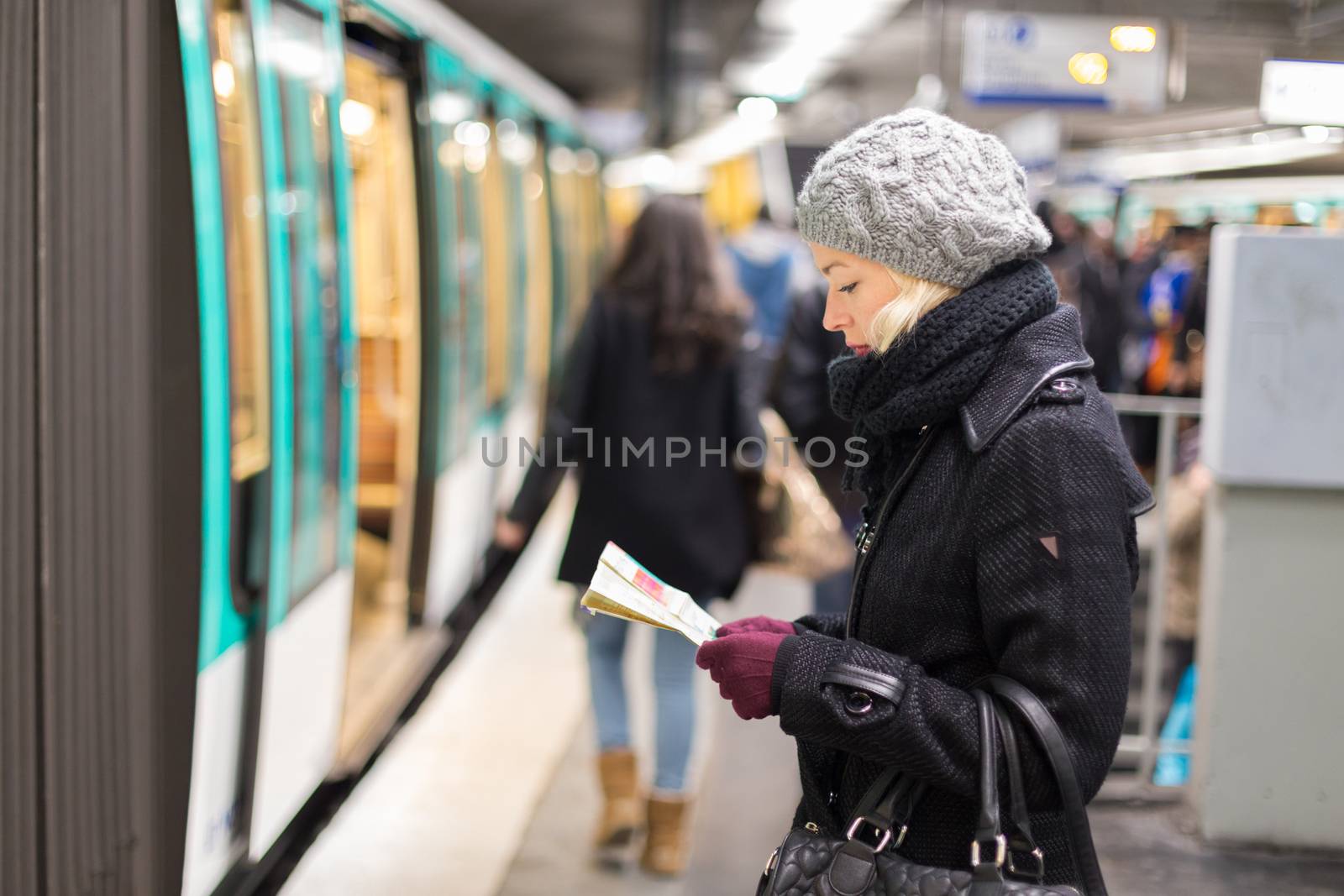 Lady waiting on subway station platform. by kasto