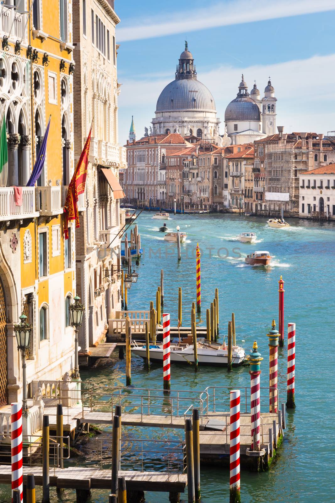 Gorgeous view of the bussy Grand Canal and Basilica Santa Maria della Salute. Venice, Italy. 
