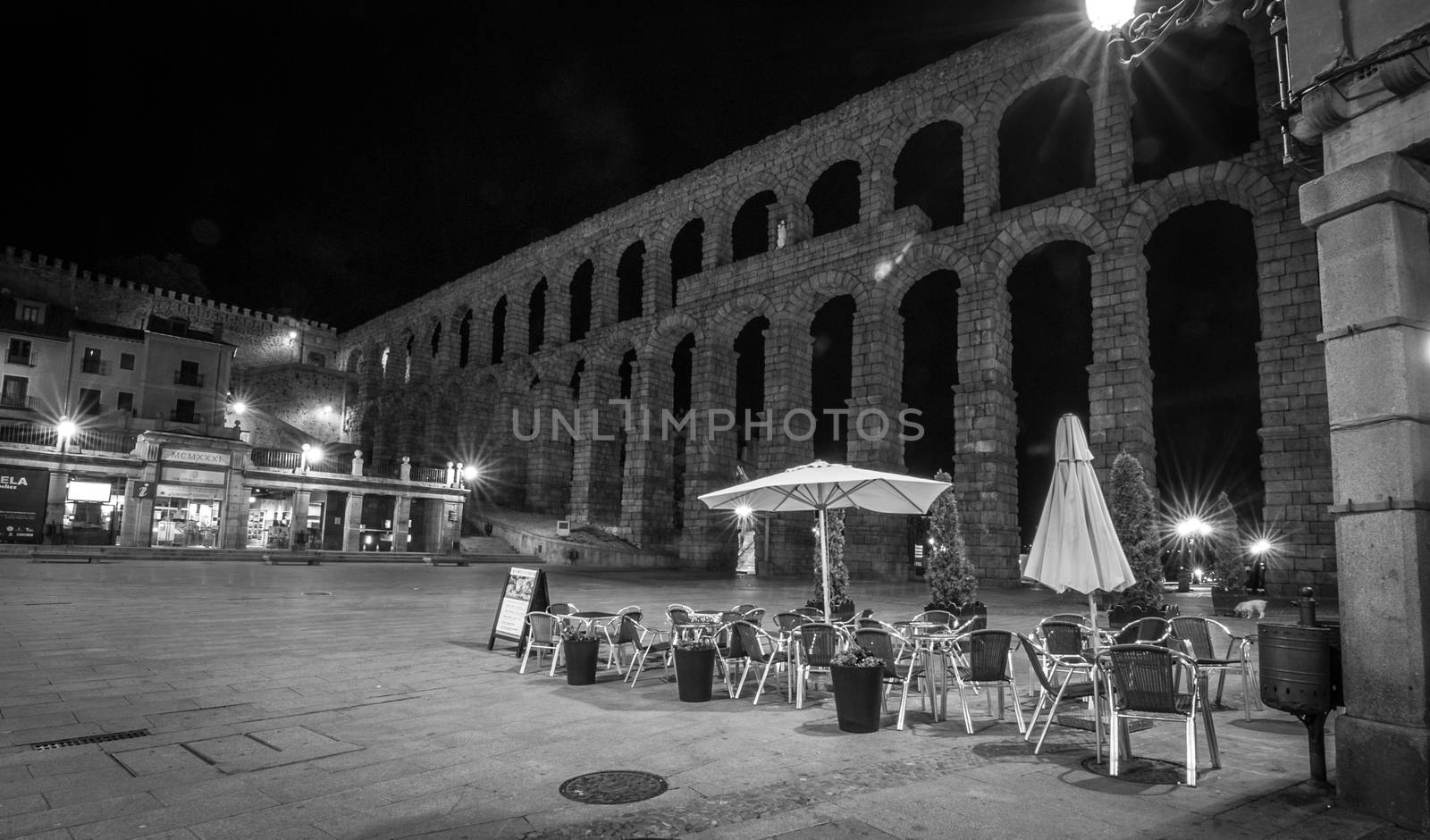 The magnificent Segovia Aqueduct in black and white at night.