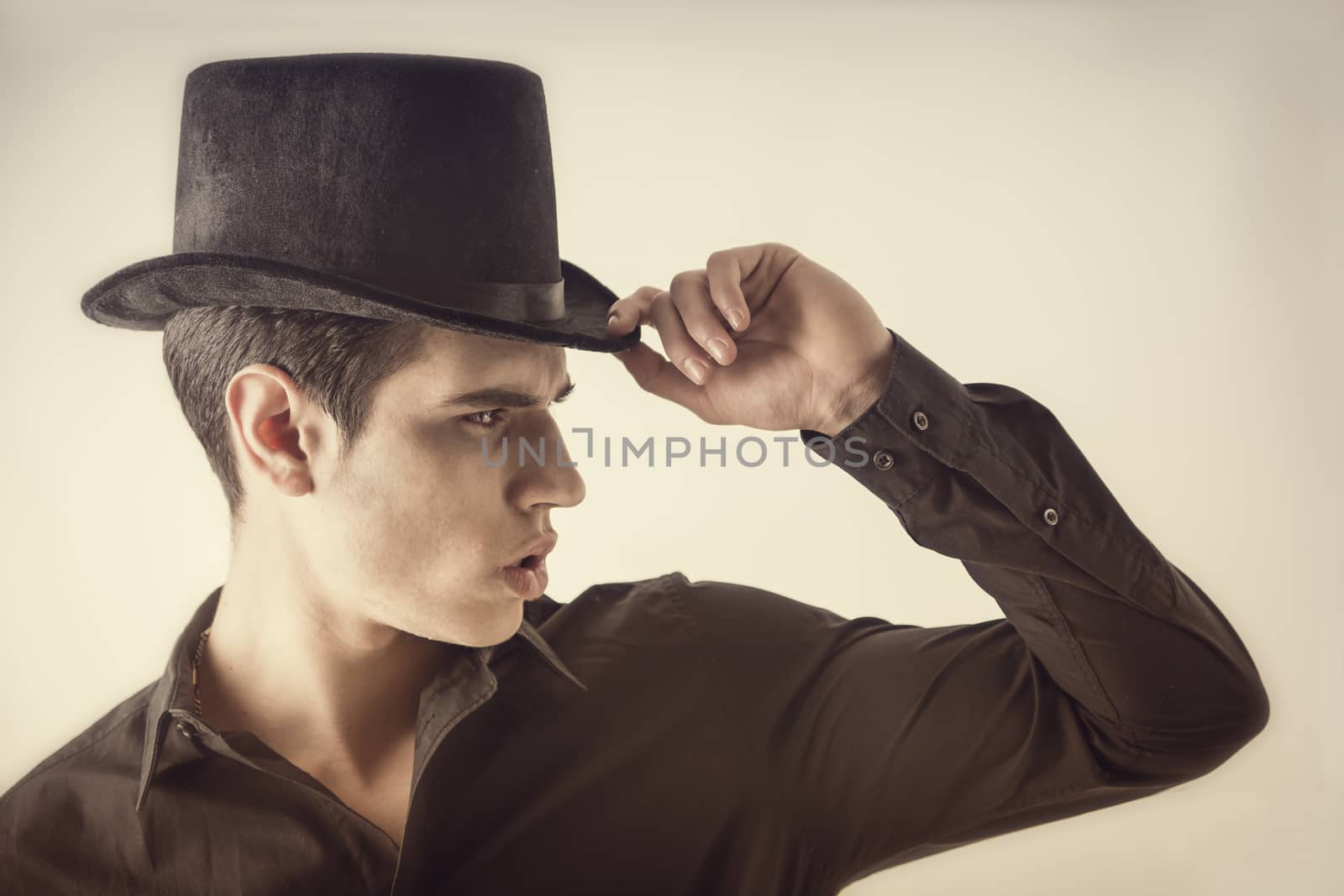 Portrait of a Young Vampire Man with Black Shirt and Top Hat, Tipping his Hat, looking to right