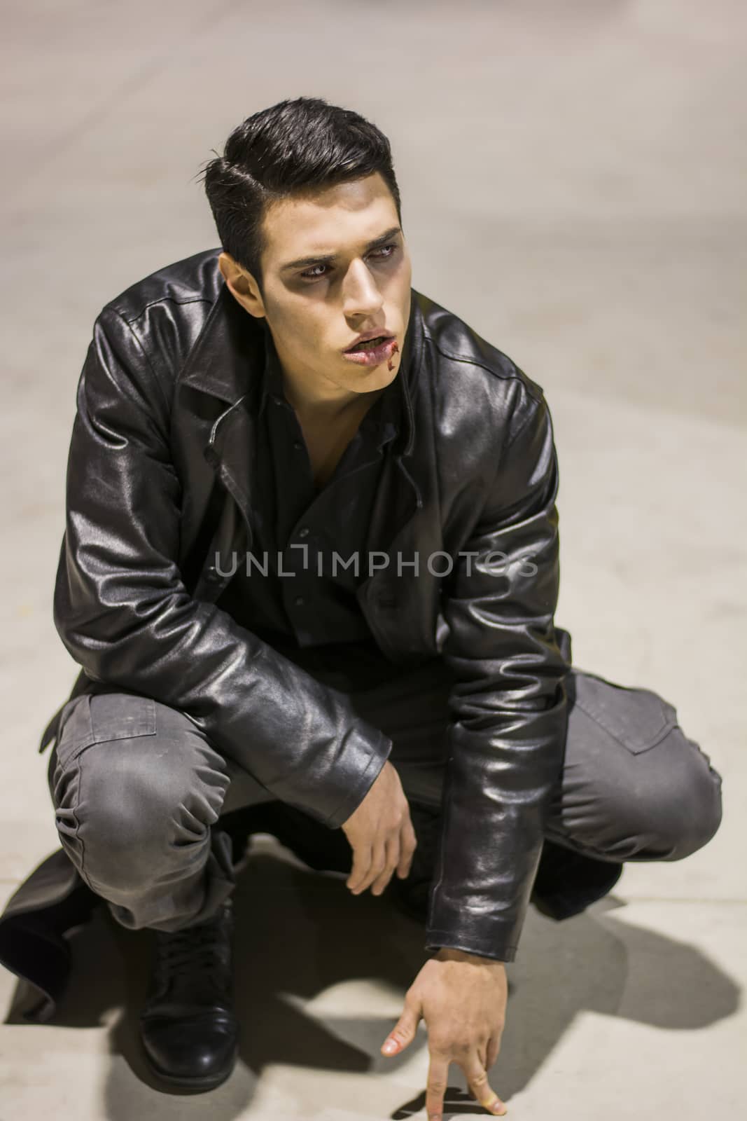Young Vampire Man with Black Leather JacketPortrait of a Young Vampire Man with Black Leather Jacket Sitting on Floor
