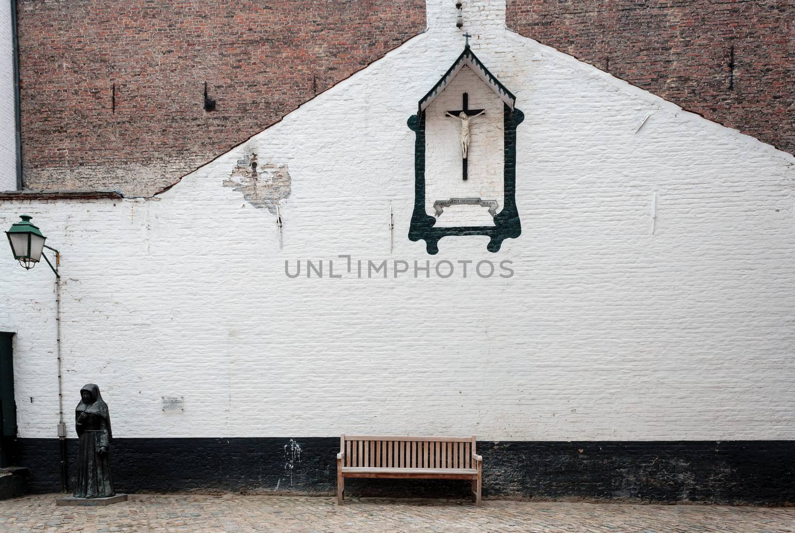 Bench and crucifix in the Beguinage  Belgium