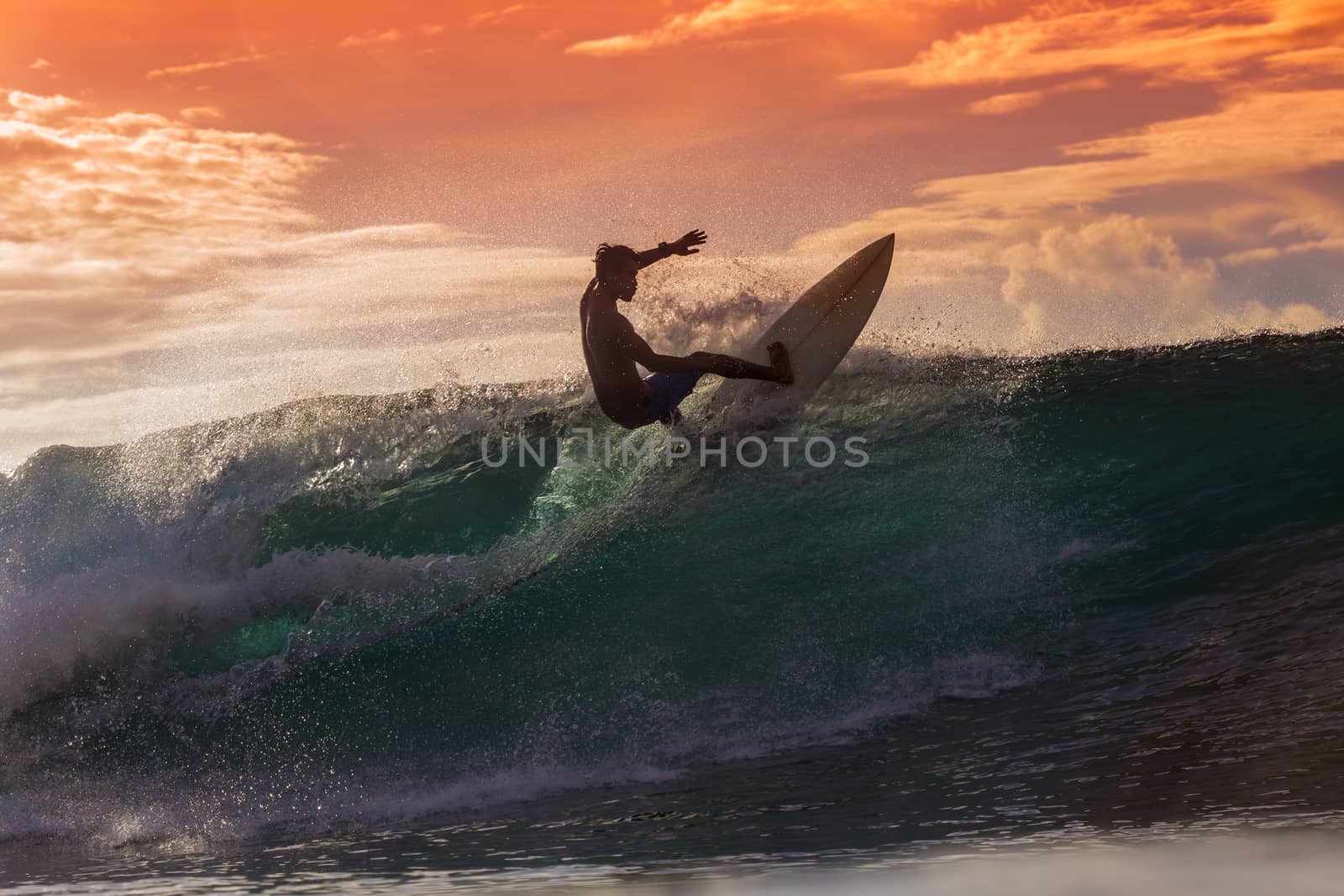 Surfer on Amazing Wave at sunset time, Bali island.