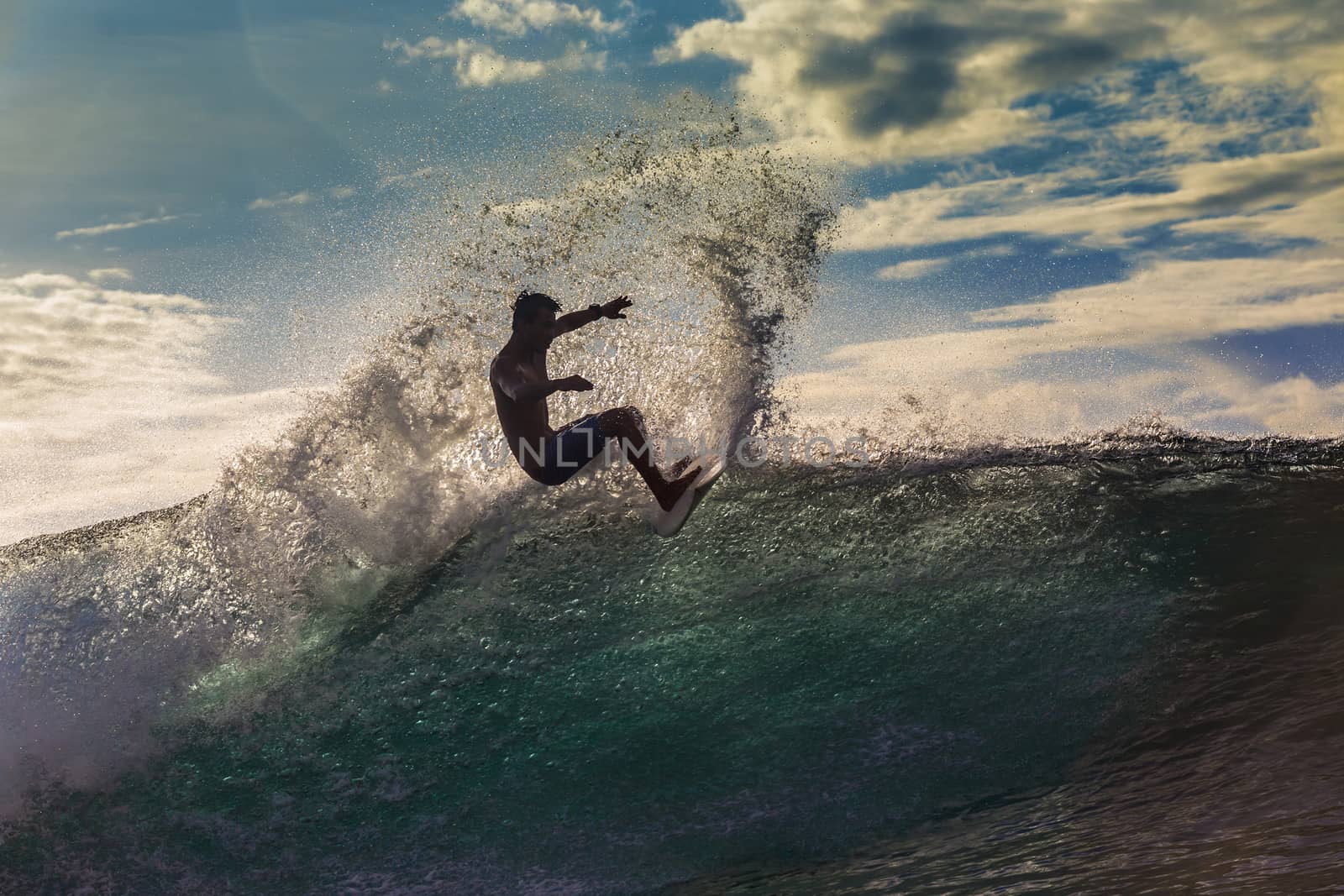 Surfer on Amazing Wave at sunset time, Bali island.