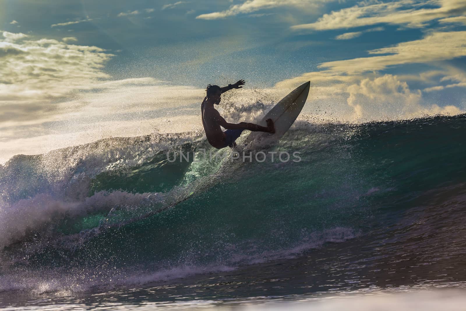 Surfer on Amazing Wave at sunset time, Bali island.